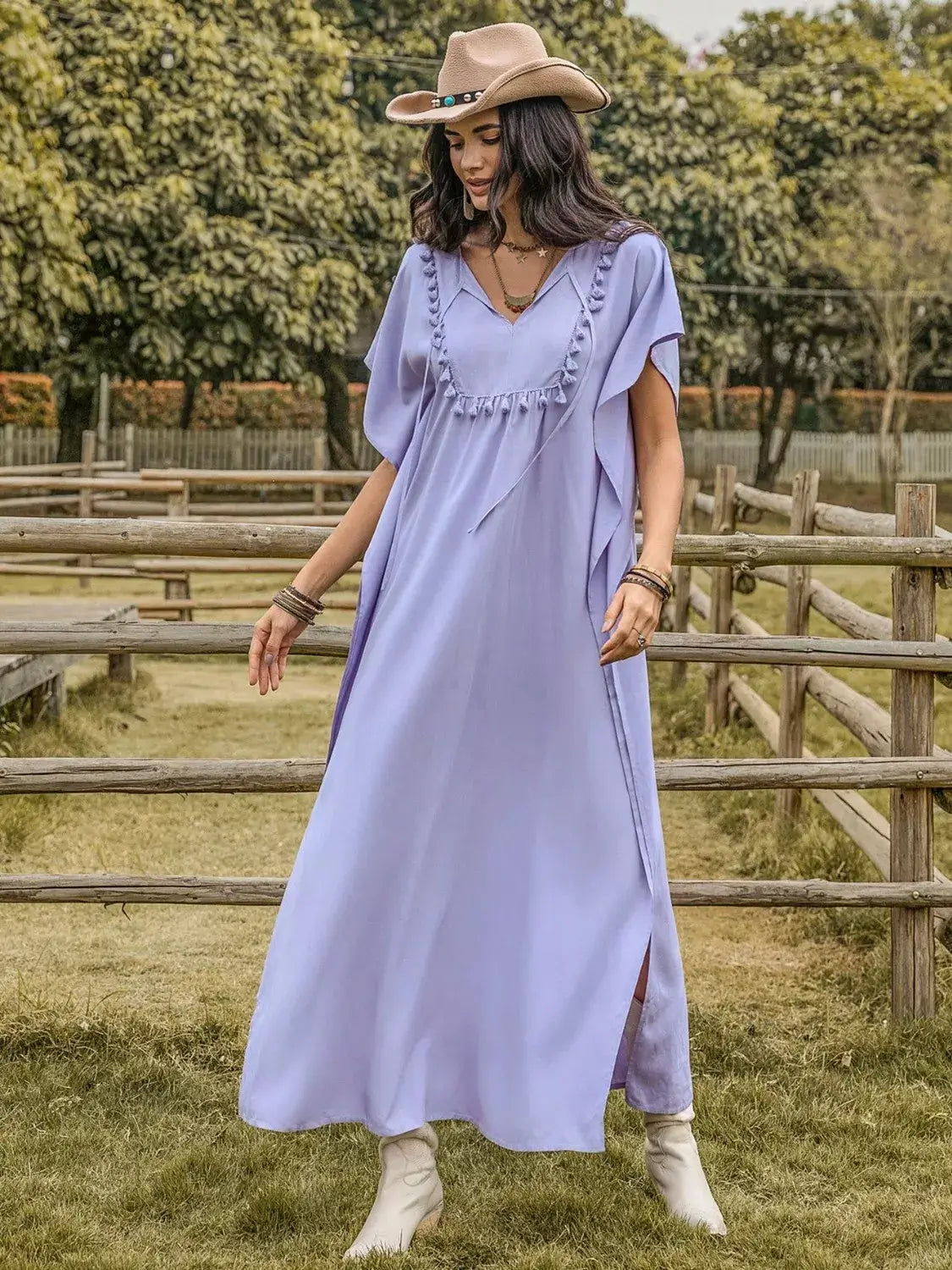 Woman wearing a Side Slit Tie Neck Flutter Sleeve Dress in lavender, showcasing elegance with a tie neck and flutter sleeves.