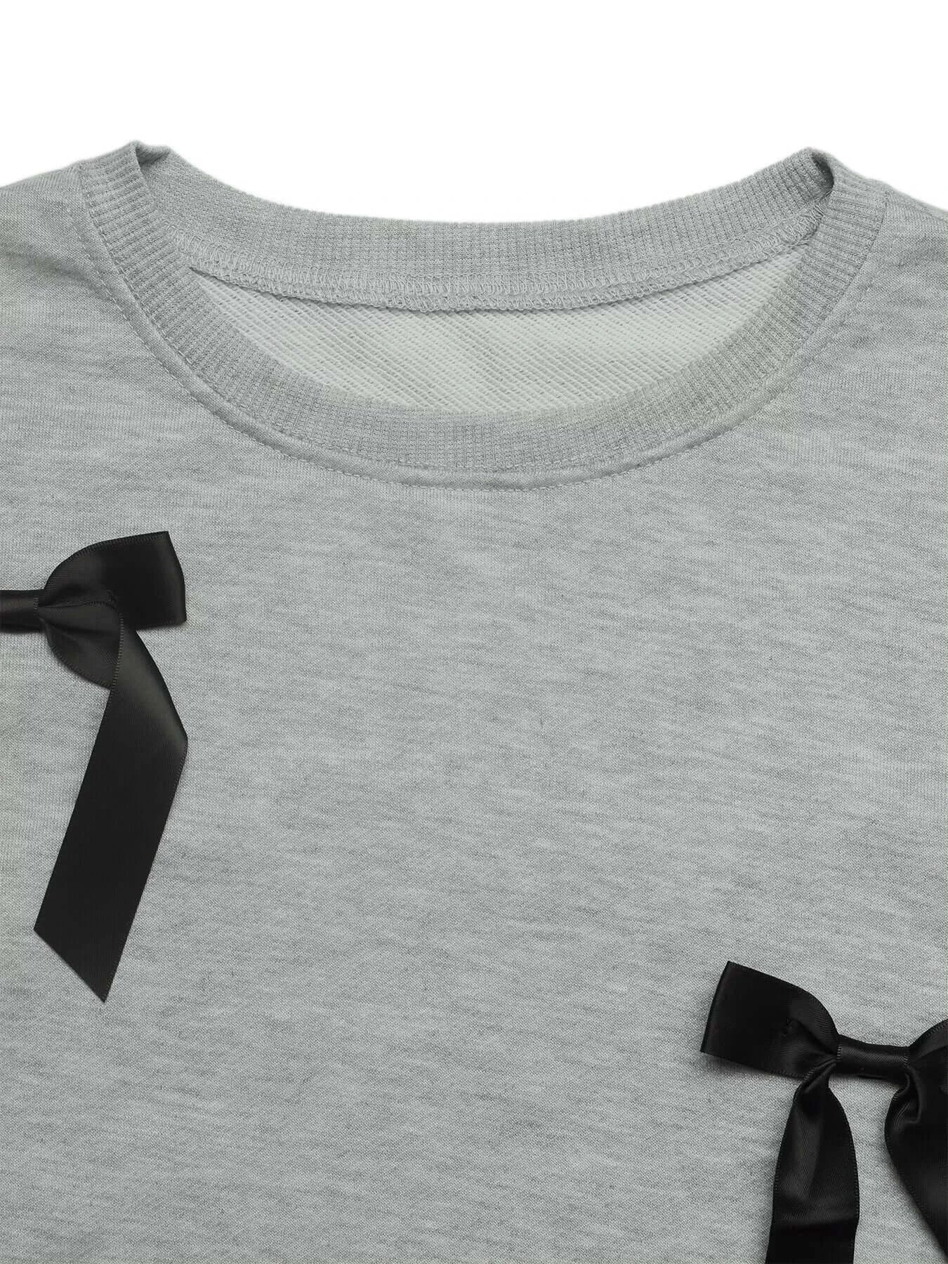 Close-up of Bow Detail Round Neck Sweatshirt showcasing black bow accents on a gray fabric.