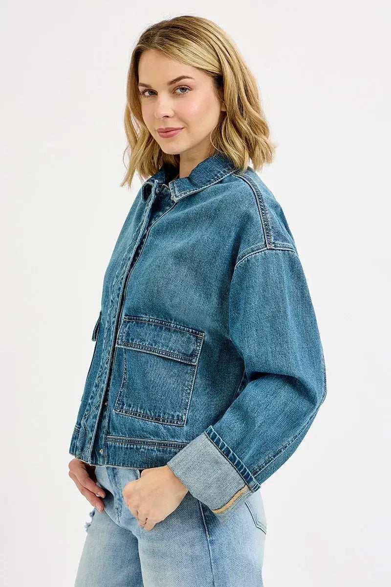 Model wearing RISEN Oversized Cargo Denim Jacket with cuffed sleeves and structured pockets.