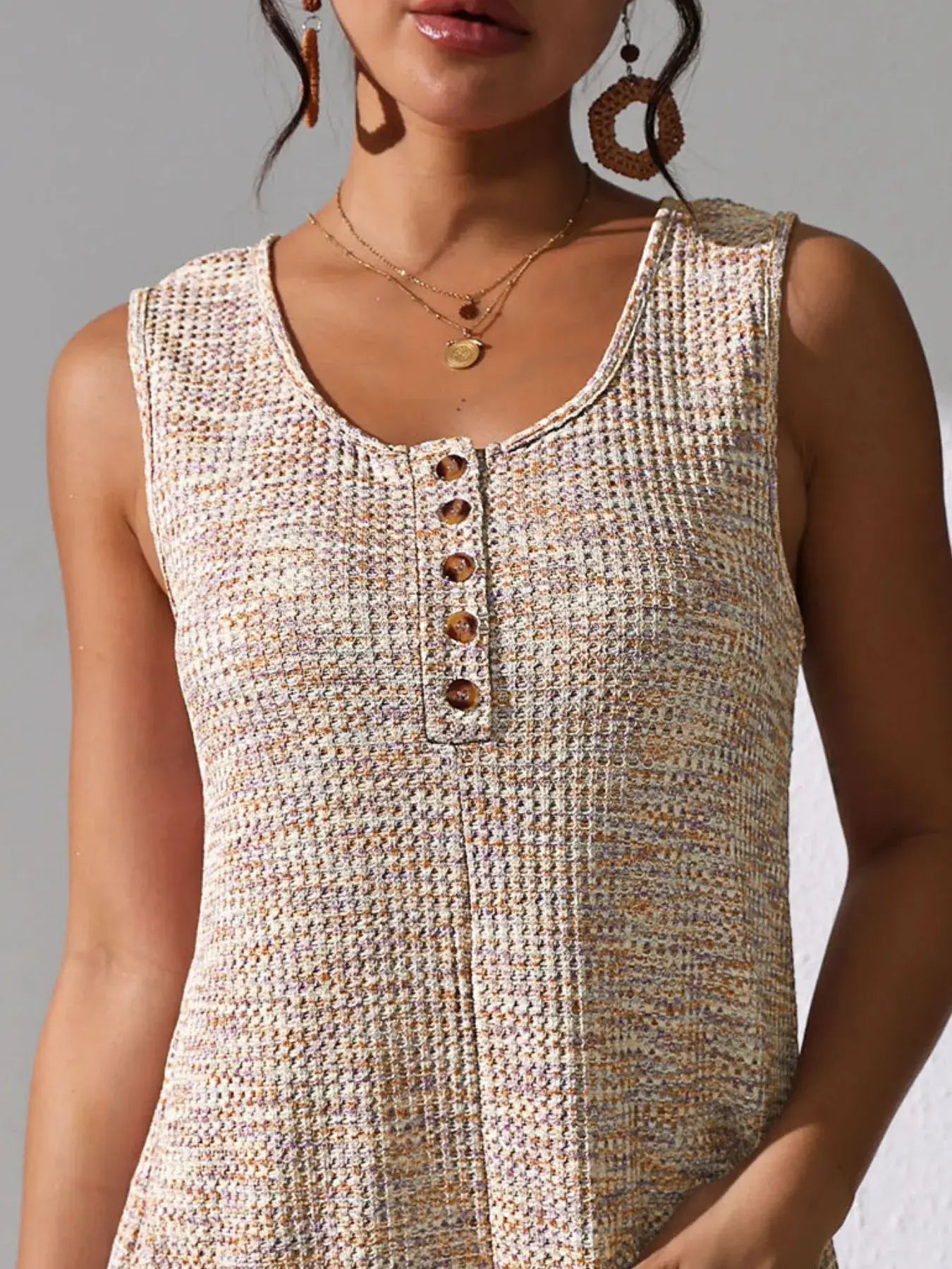 Full Size Button Front Romper with Pockets in a stylish design showcasing button front detail and textured fabric.