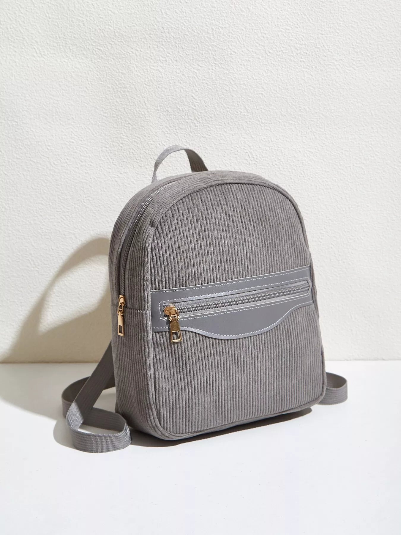 Casual Corduroy Backpack Bag for Daily Urban Use in gray color with a front zipper pocket.