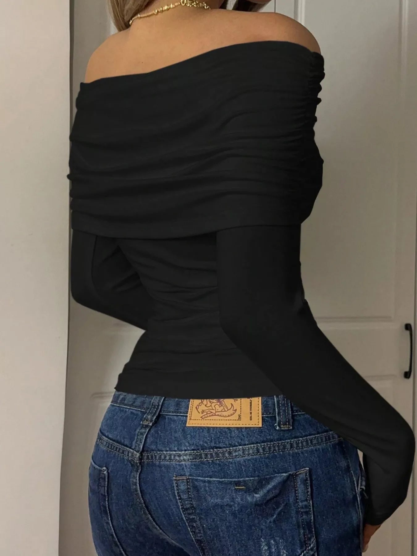 Off-Shoulder Ruched Long Sleeve T-Shirt in black, featuring a stylish ruched design and slightly stretchy material.