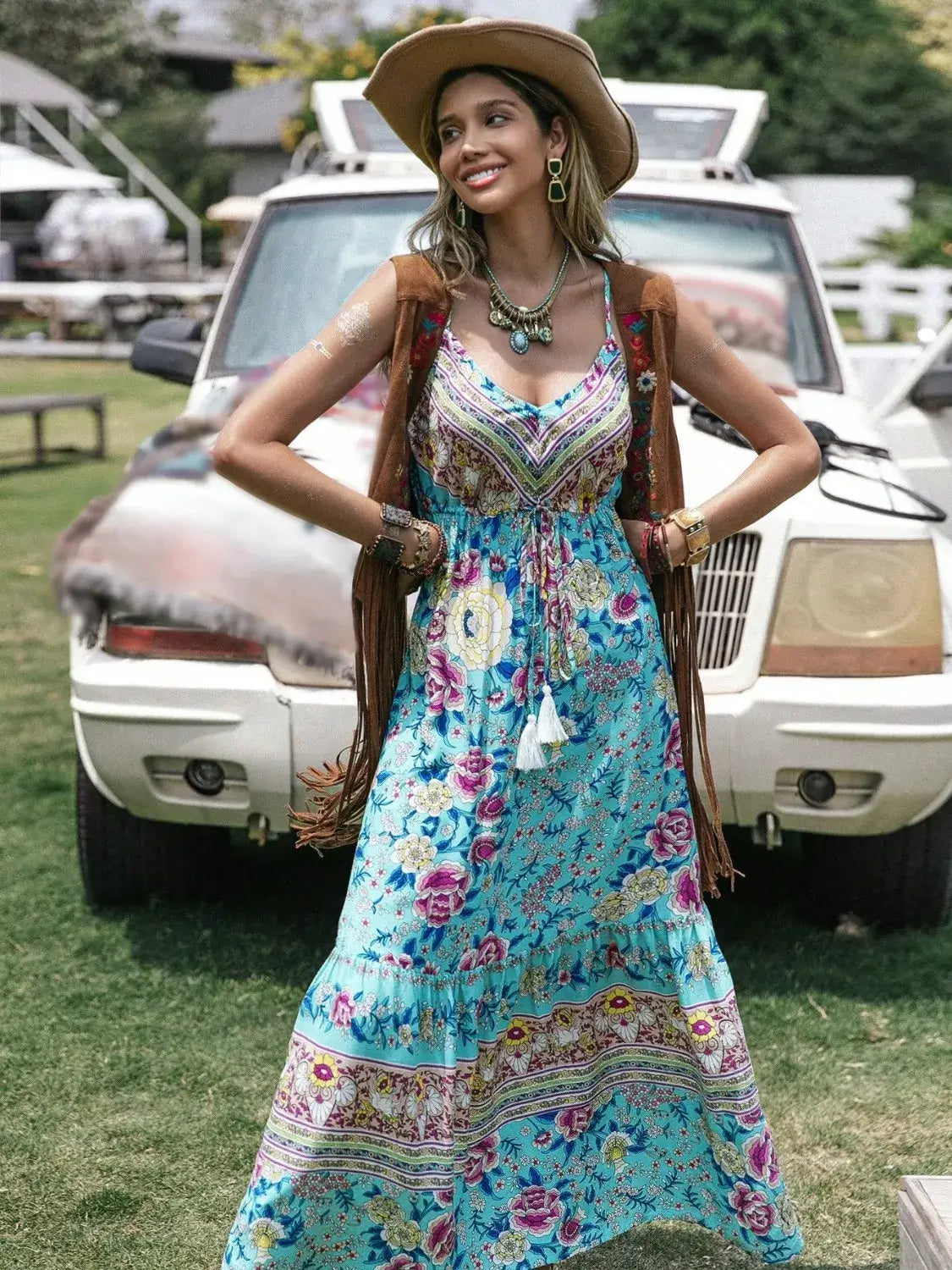 Tassel Floral Print Tiered Cami Dress worn by a model outdoors, showcasing bohemian style with vibrant floral patterns.