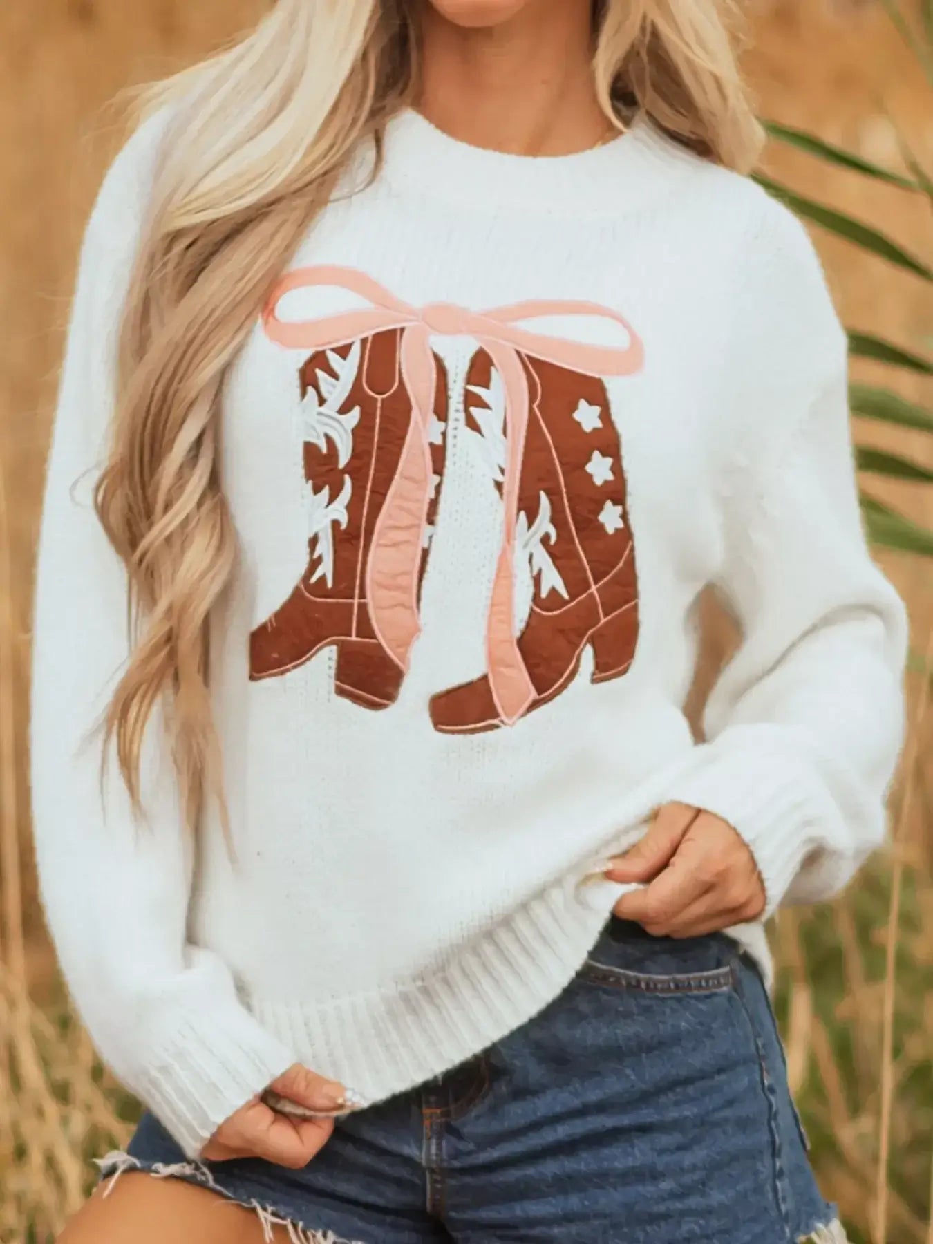 Embroidered bow boots graphic drop shoulder sweater featuring playful boots and bows design on a cozy knit.