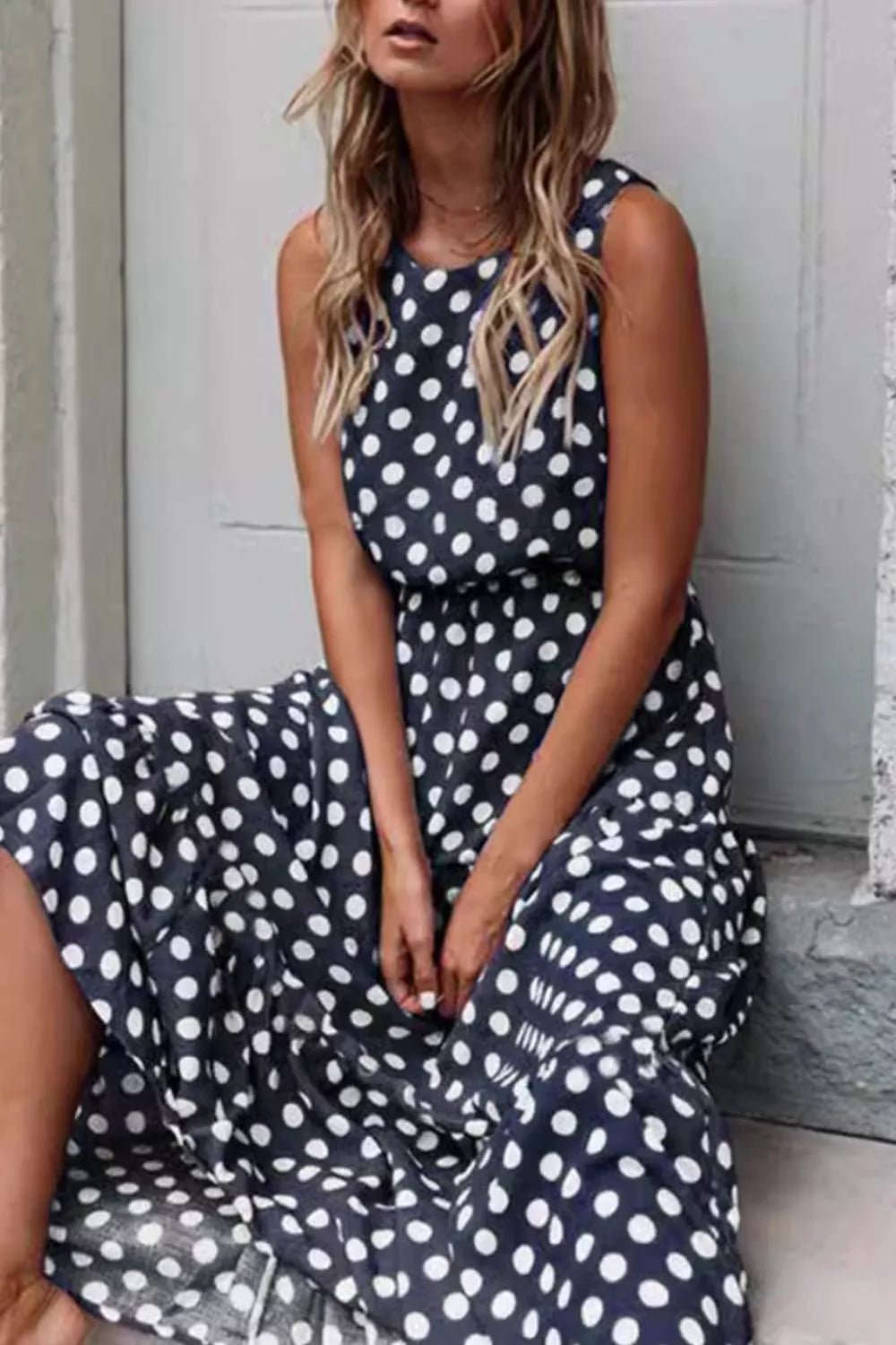 Sleeveless Polka Dot Casual Dress displayed on a model, featuring a navy background and white polka dots, perfect for summer.
