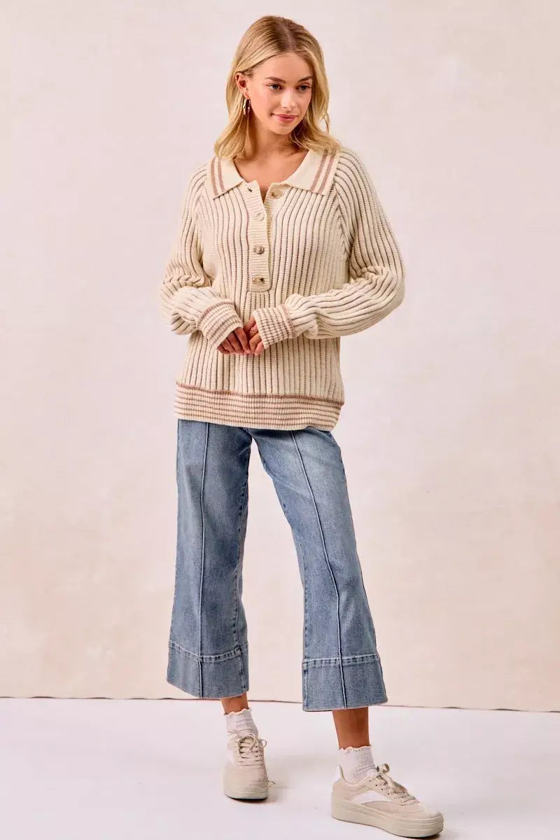 BiBi half button ribbed two tone sweater styled with wide-leg jeans and sneakers, showcasing casual knit elegance.