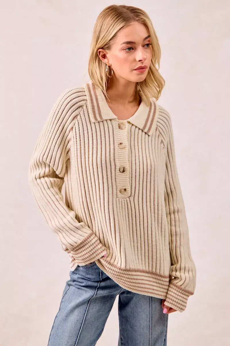 Model wearing a BiBi half button ribbed two tone sweater in a cozy knit style, showcasing button-front detail.