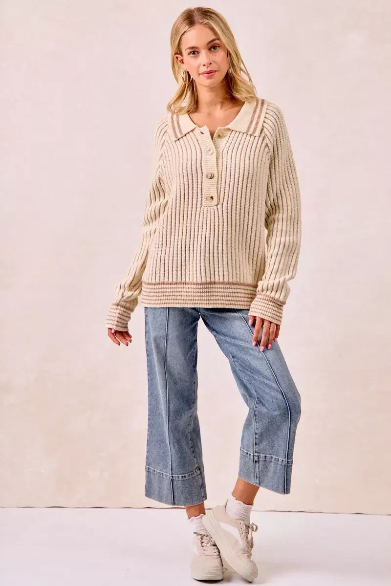 Woman modeling the bibi half button ribbed two tone sweater with relaxed denim and sneakers.