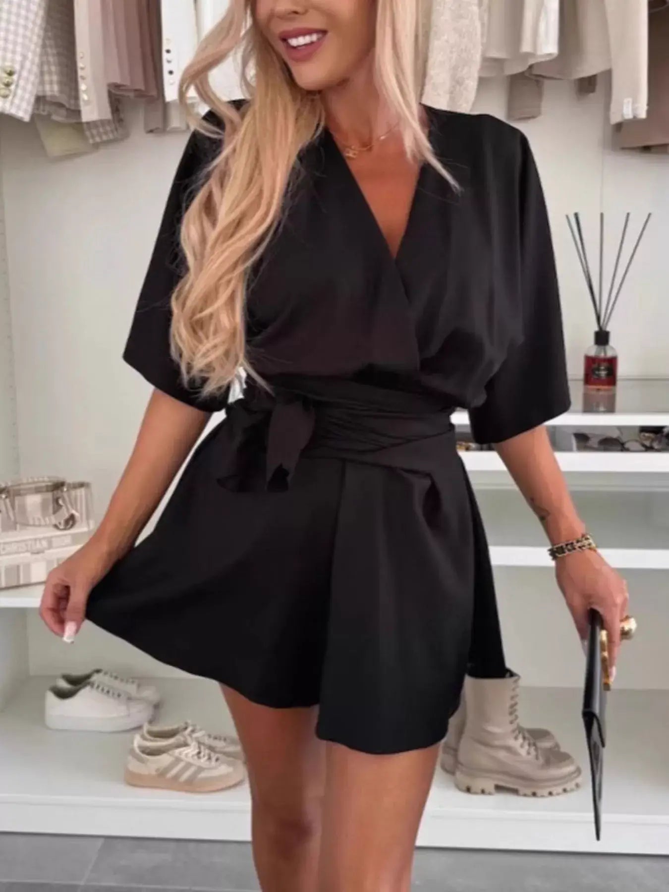 Full Size Surplice Tie Waist Romper styled elegantly in black with a relaxed fit and adjustable tie waist.
