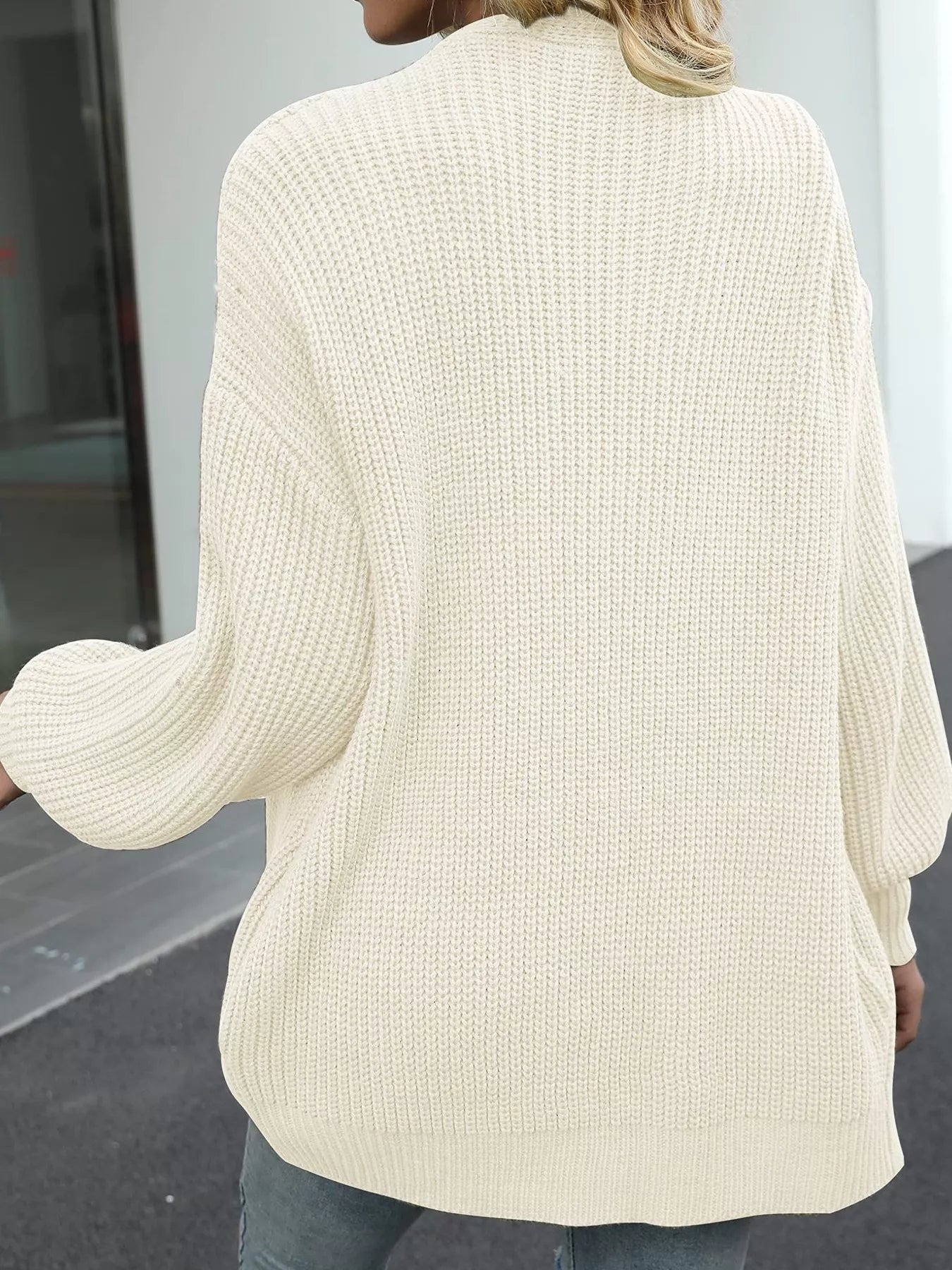 Back view of a woman wearing a Chunky Knit Open Front Cardigan, showcasing its oversized and cozy design.