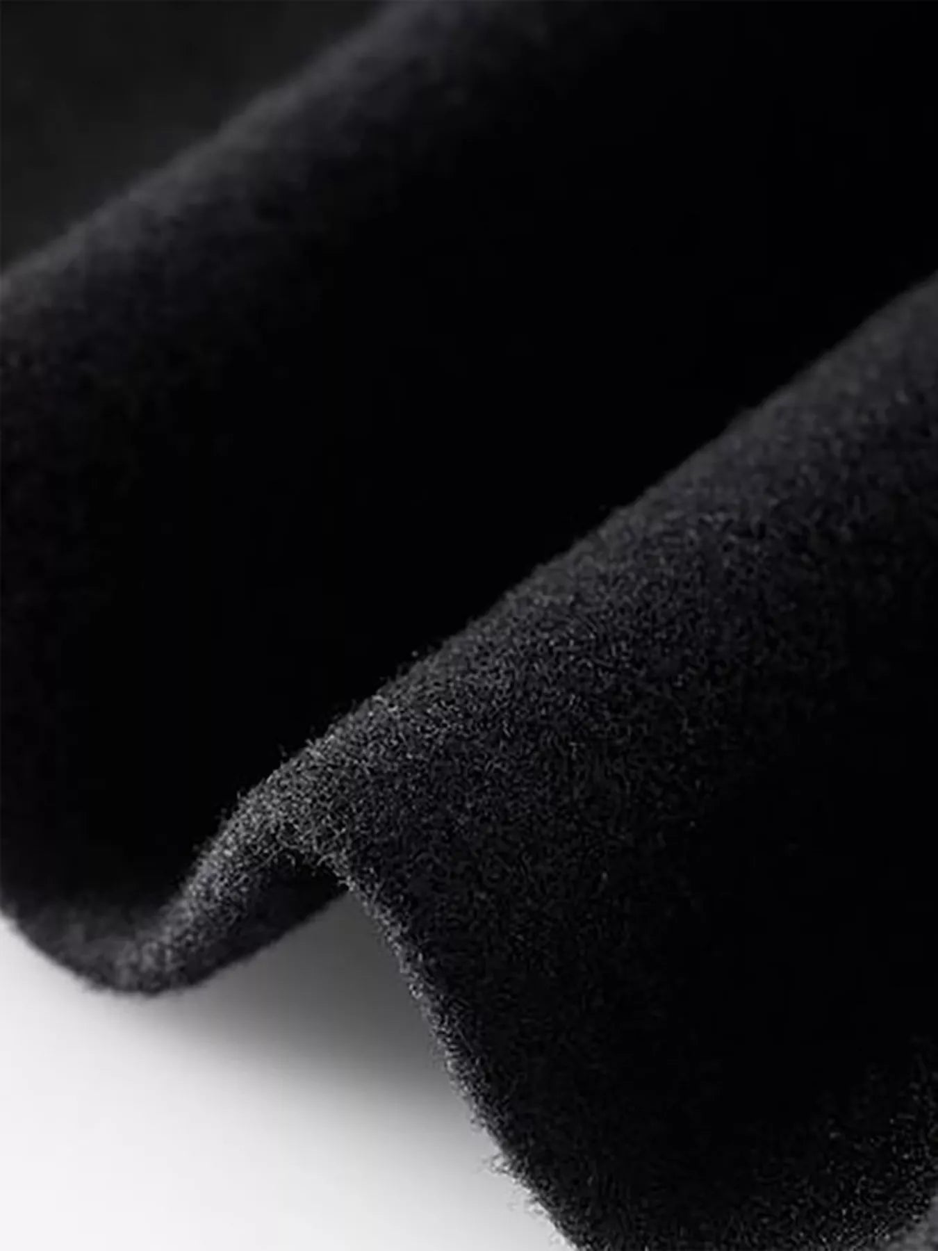 Close-up of soft black fabric showcasing the texture for Full Size Single Breasted Long Sleeve Overcoat.