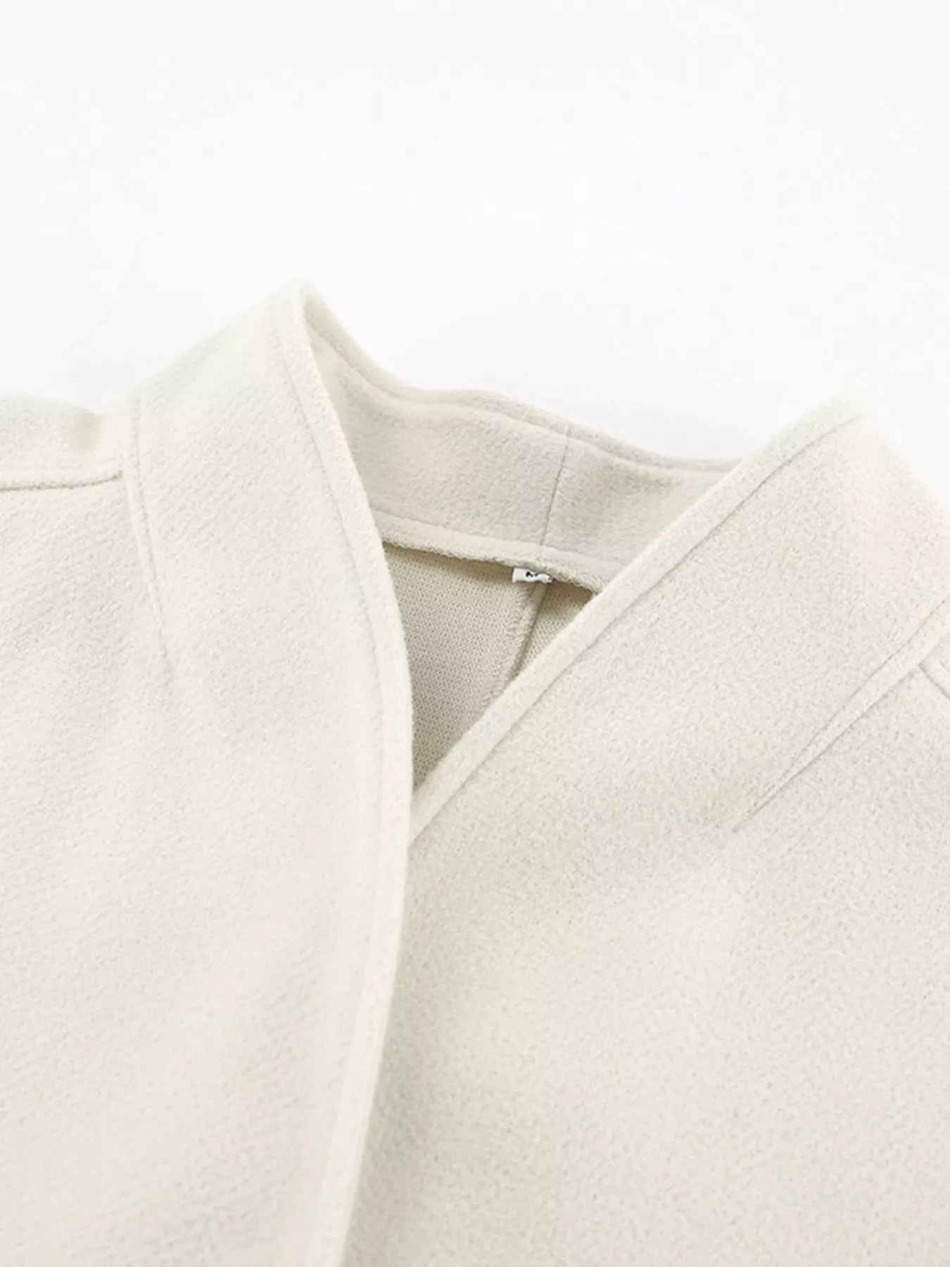 Close-up view of the collar of an Open Front Dropped Shoulder Outerwear for Women in light color.