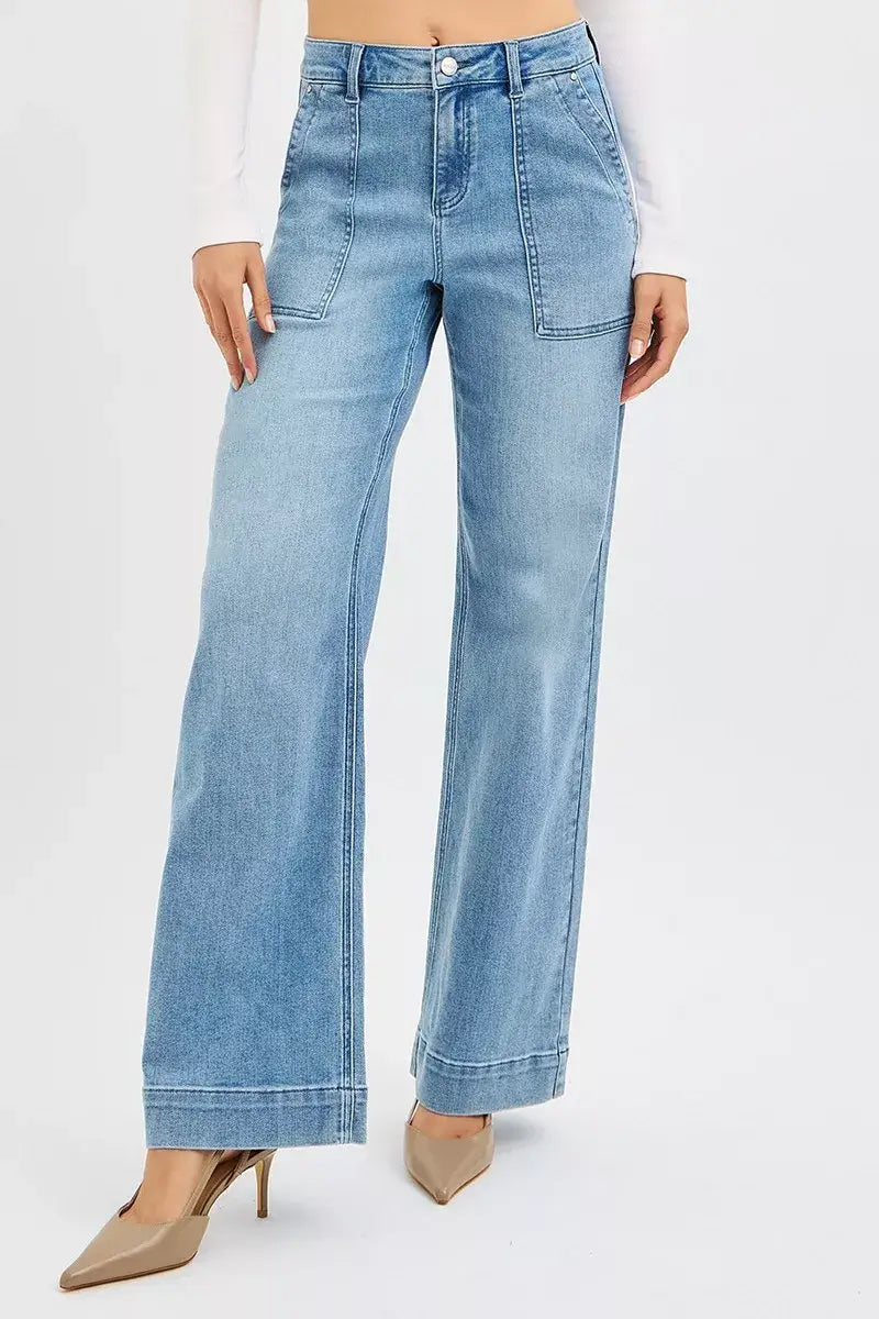 RISEN High Rise Straight Leg Jeans Plus Size in light blue with front pockets, styled with a fitted top and heels.