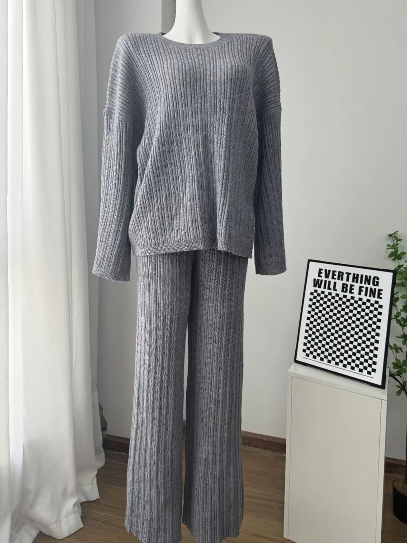 3 Piece Ribbed Sweater and Wide Leg Pants Set with Scarf displayed on a mannequin in a cozy setting.