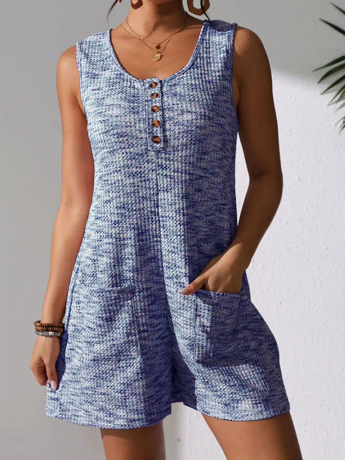 Full Size Button Front Romper with Pockets in blue knit fabric, featuring short sleeves and functional pockets.