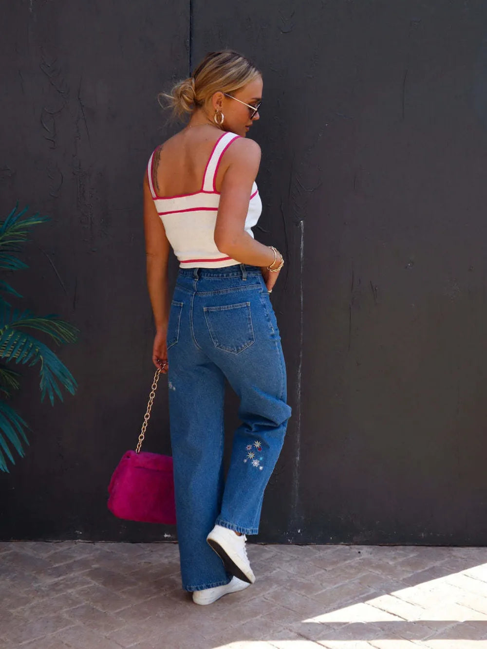 Model showcasing Embroidered Straight Jeans with Pockets, styled with a casual top and pink bag.