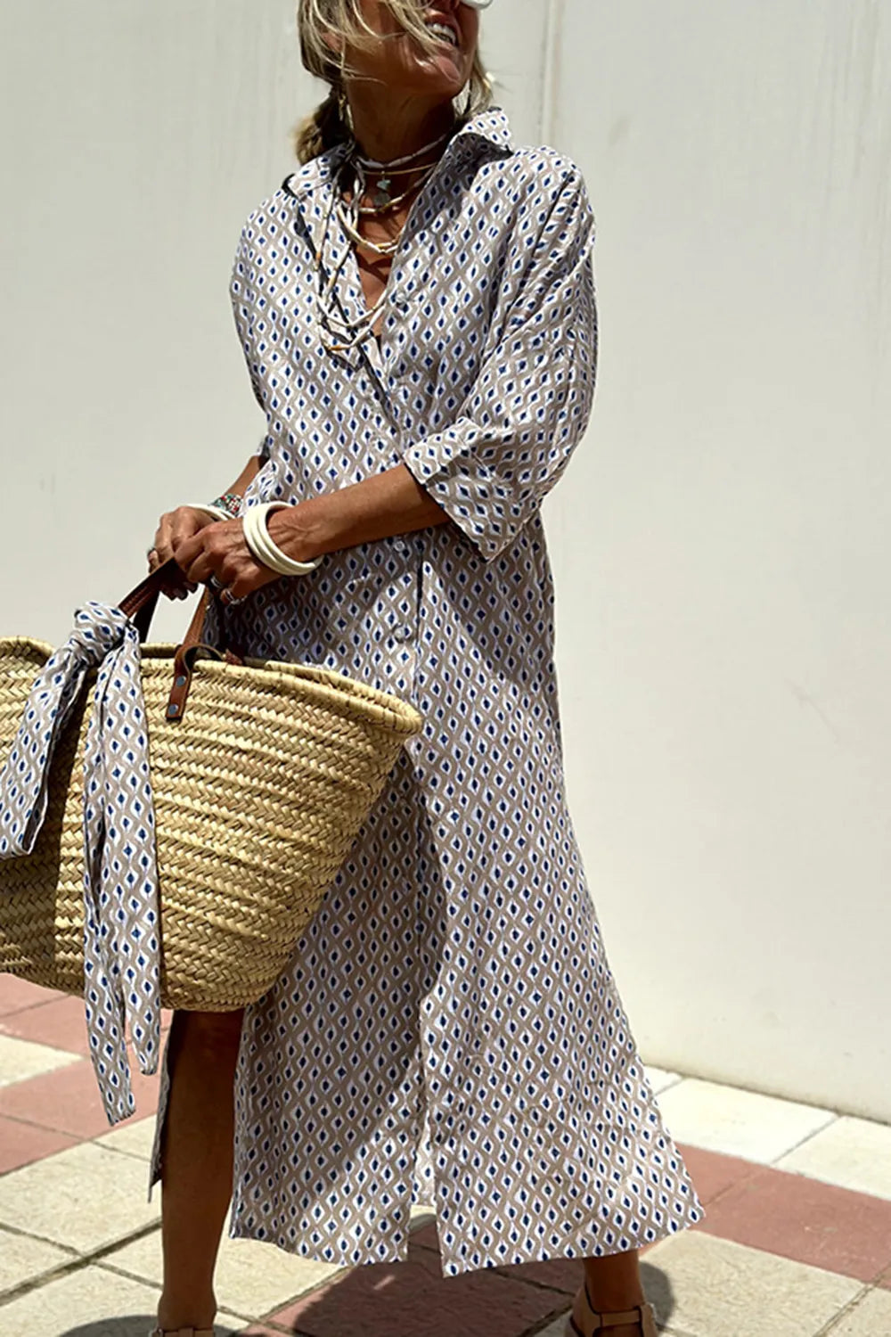 Woman wearing a Tied Button Up Three-Quarter Sleeve Dress, carrying a woven bag, enjoying a sunny day.