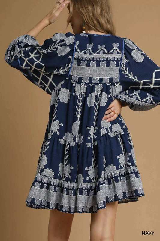 Umgee Tribal Print Dress with Tie Neck featuring balloon sleeves and a relaxed fit in navy blue.