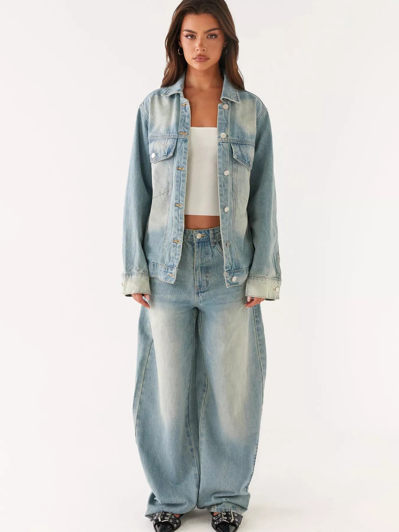 Model wearing a Button Up Denim Jacket and Jeans Set in light blue, featuring a buttoned design and oversized fit.