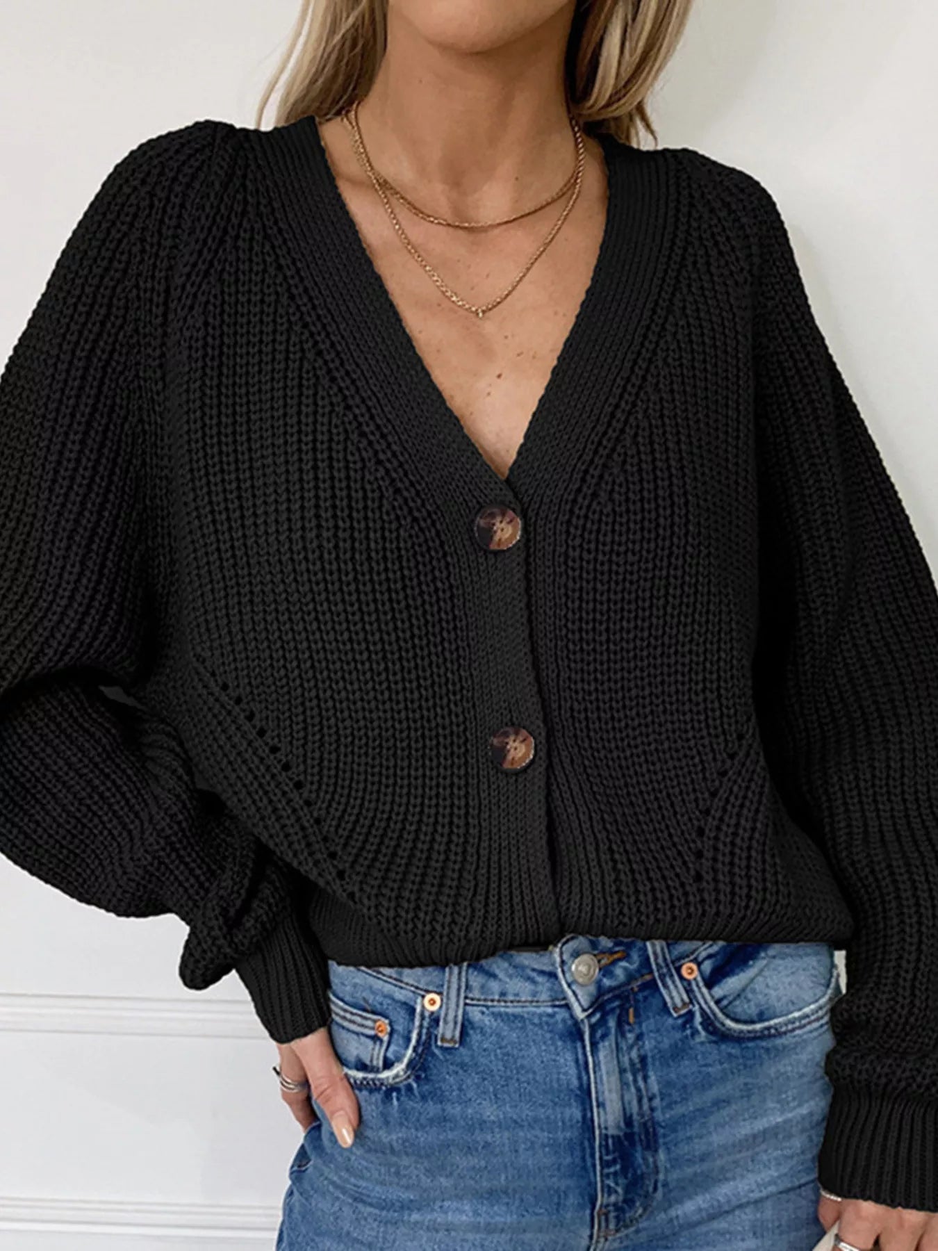 Chunky Knit Button Down Cardigan in black, featuring a v-neck, button-up style, paired with denim jeans.