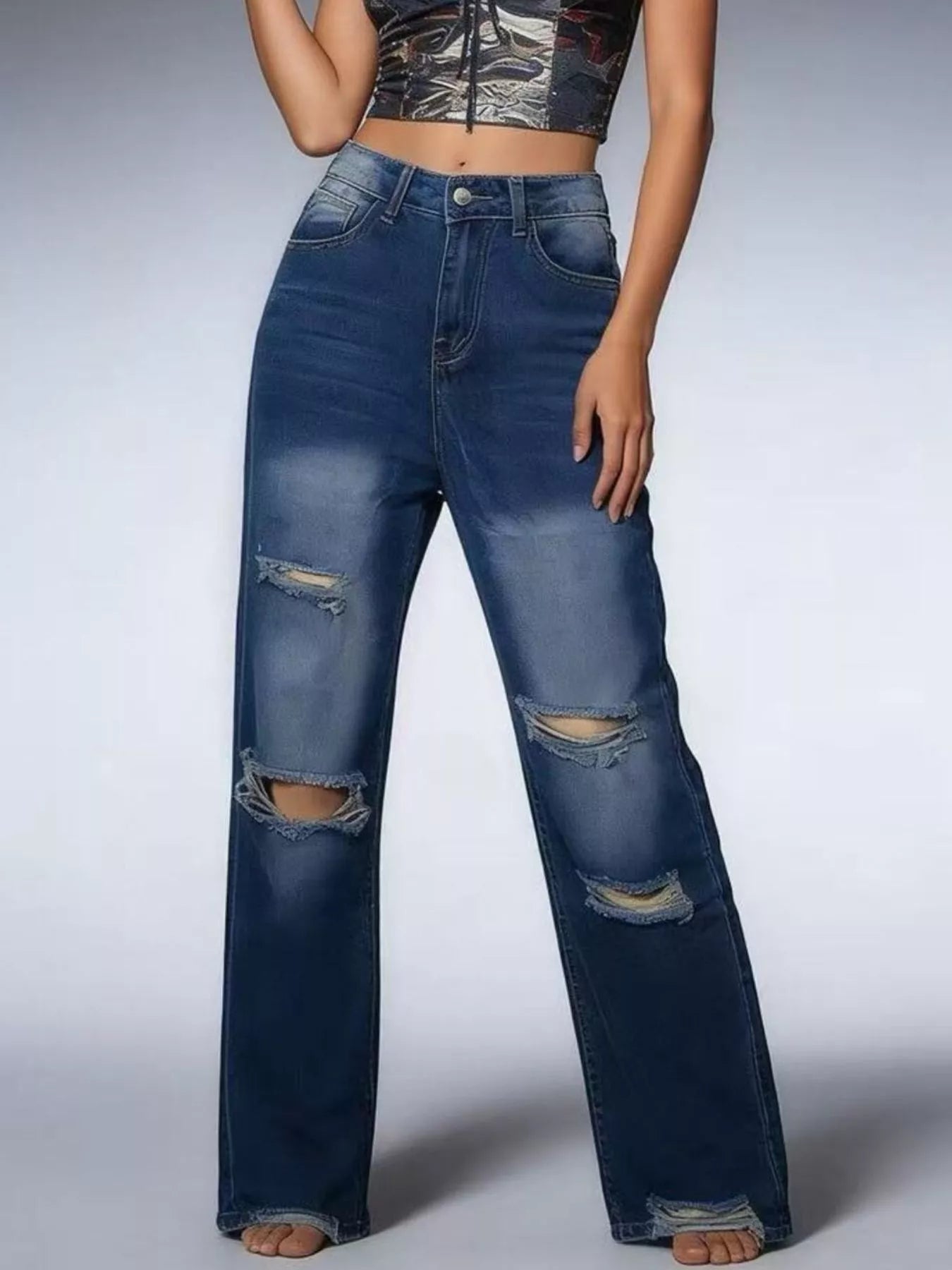 Distressed Wide Leg Jeans with buttoned pocketed design and ripped detailing, styled with a crop top.