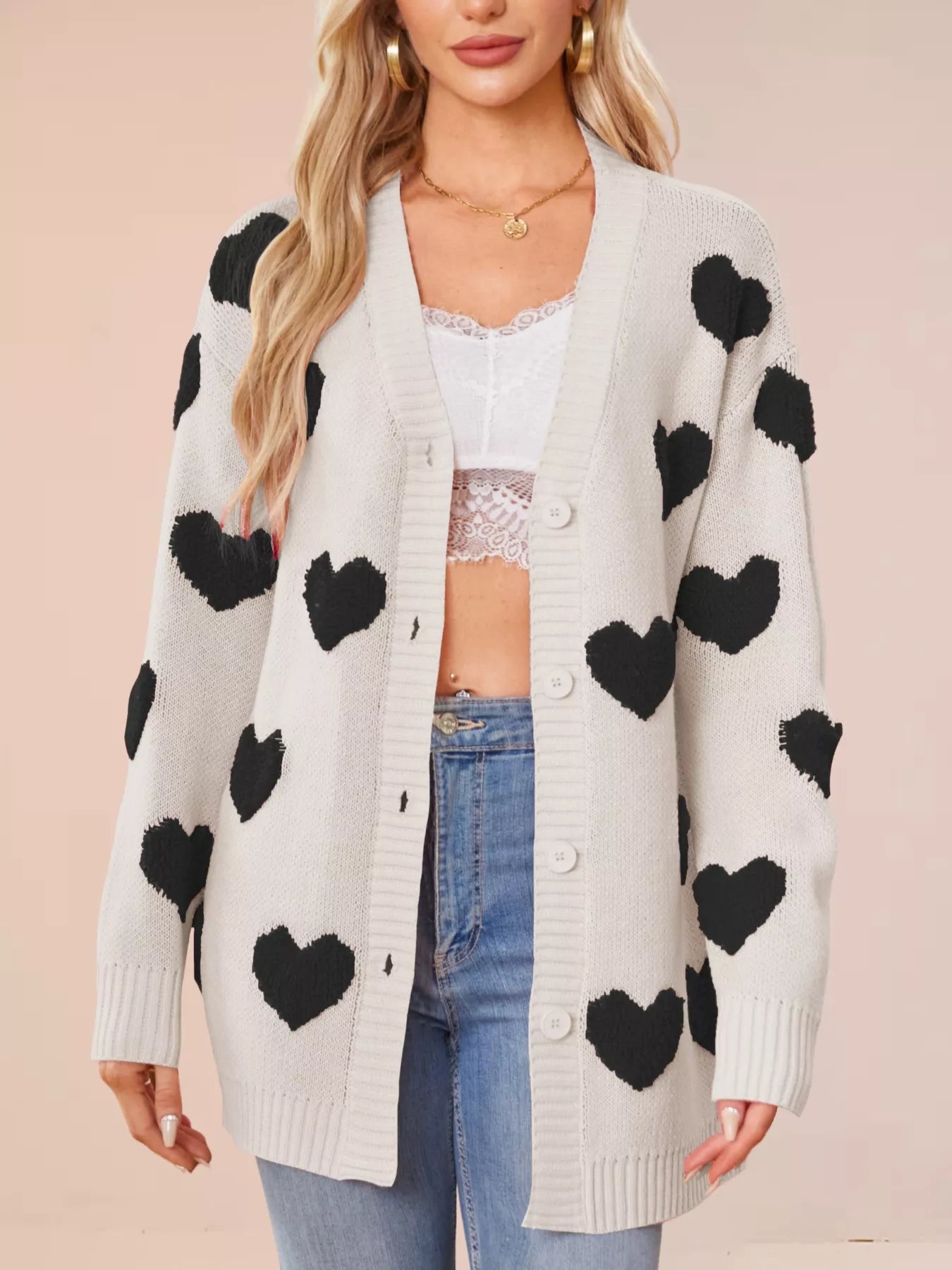 Heart Pattern Knit Button Up Cardigan for Women styled with black hearts on a light gray background
