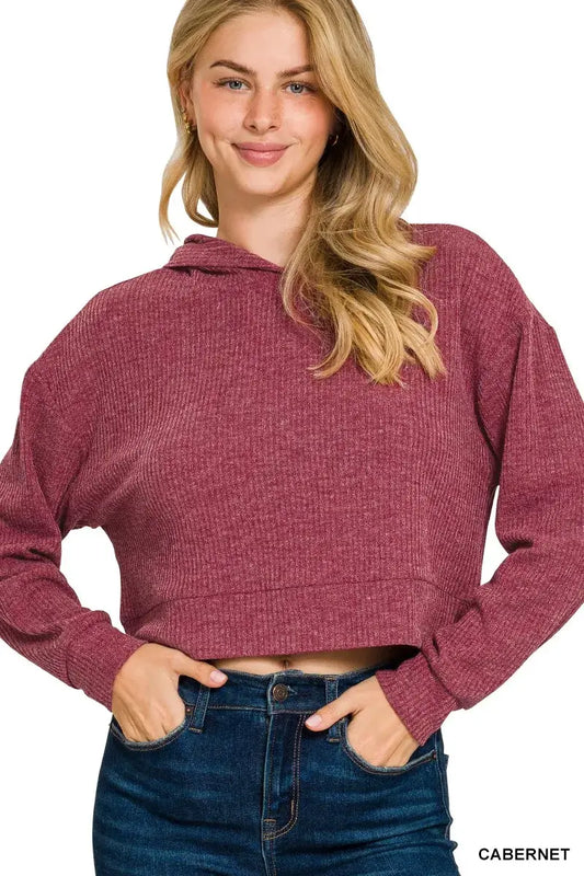 Zenana Drop Shoulder Ribbed Crop Hoodie in cabernet color worn casually by a model with a smile.