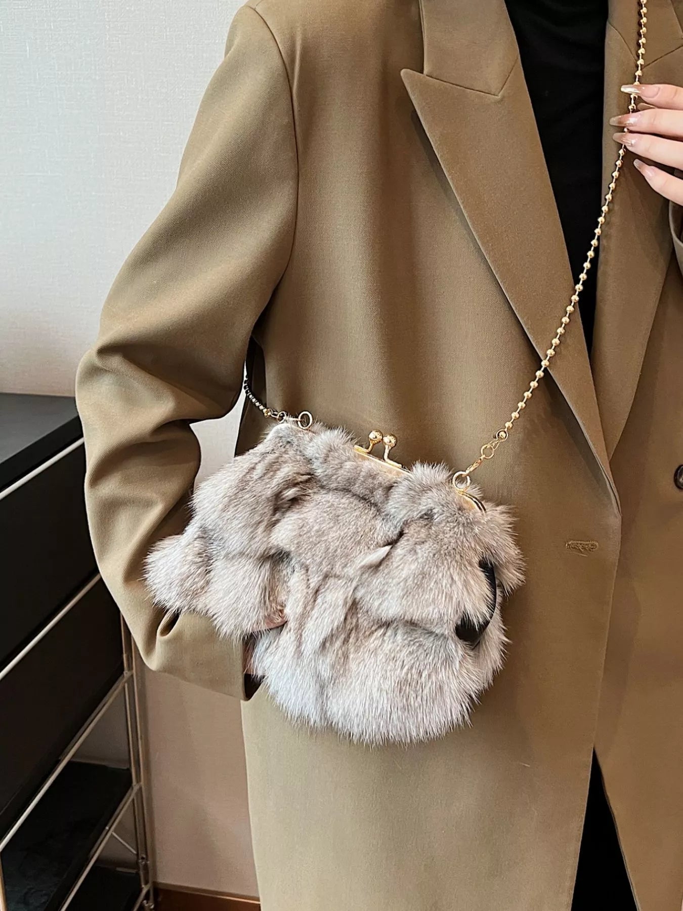 Furry Chain Crossbody Bag worn by a model with a beige coat, showcasing its soft fox fur material.