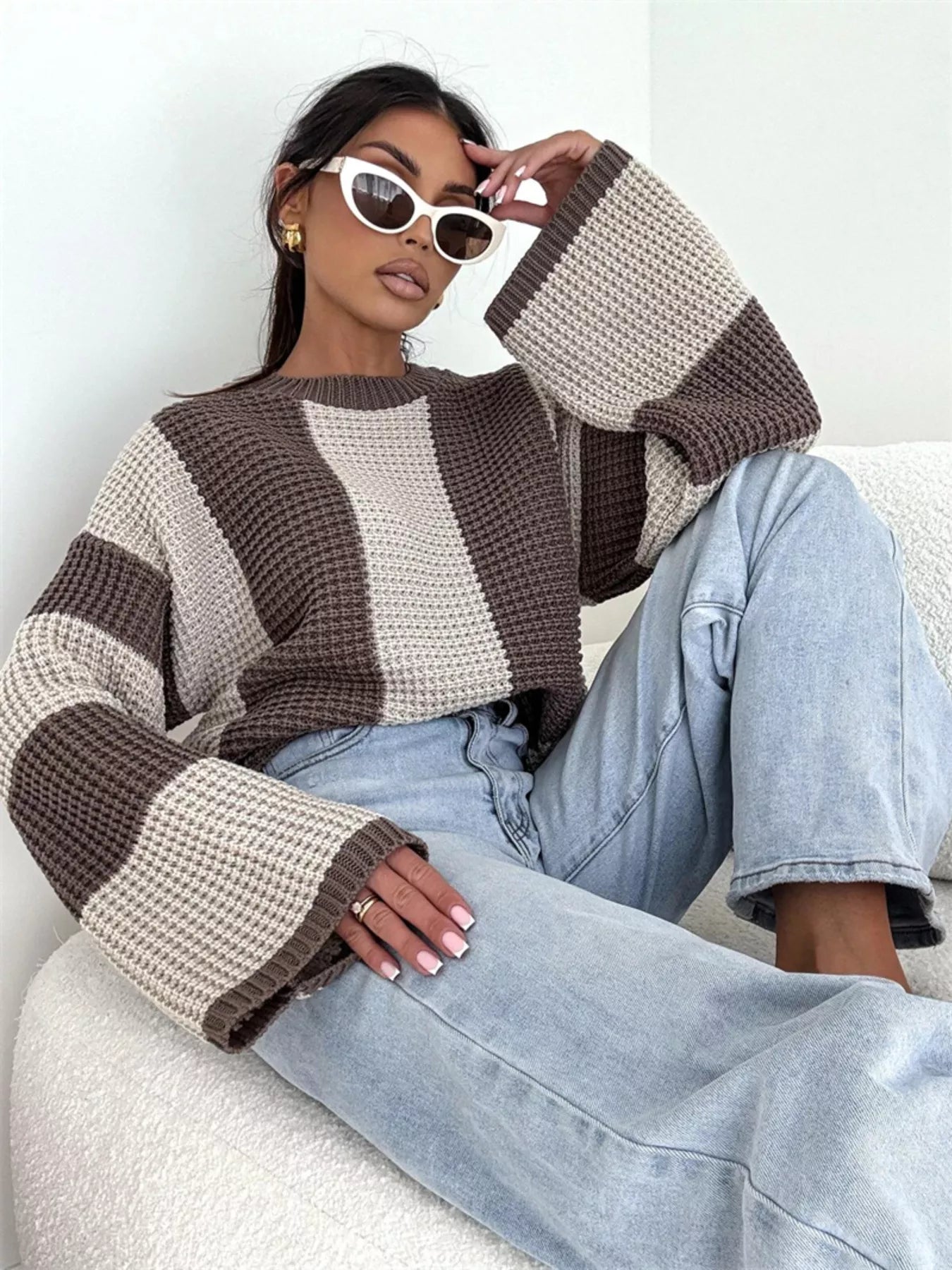 Model wearing a Color Block Long Sleeve Sweater with oversized sleeves and stylish accessories.