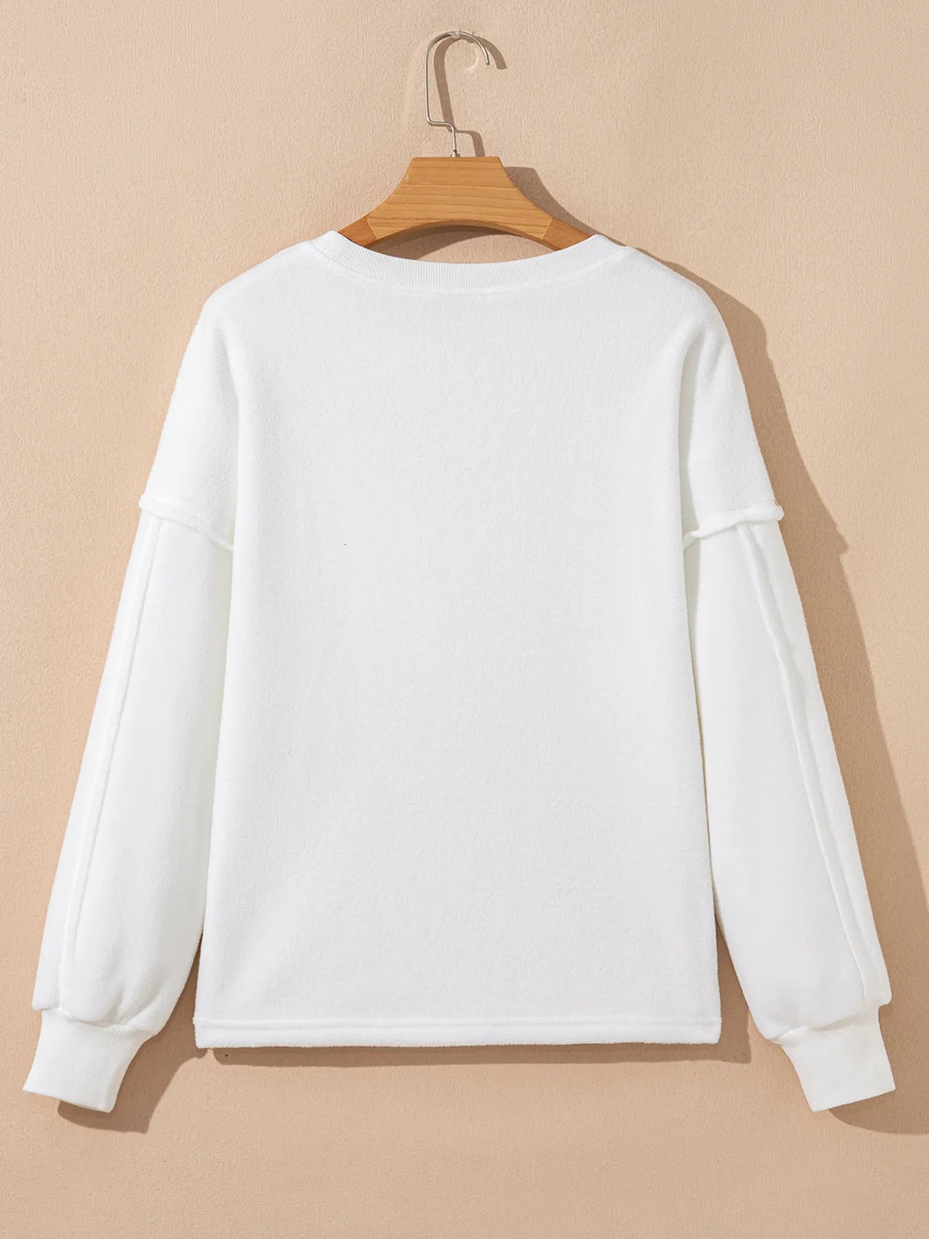 Back view of Exposed Seam Chest Pocket Knit Pullover Sweatshirt in white, featuring long sleeves and a relaxed fit.
