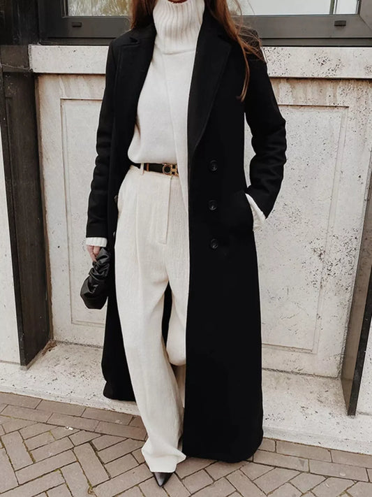 Woman wearing a Double Breasted Longline Overcoat with a turtleneck and wide-leg pants, showcasing contemporary chic style.