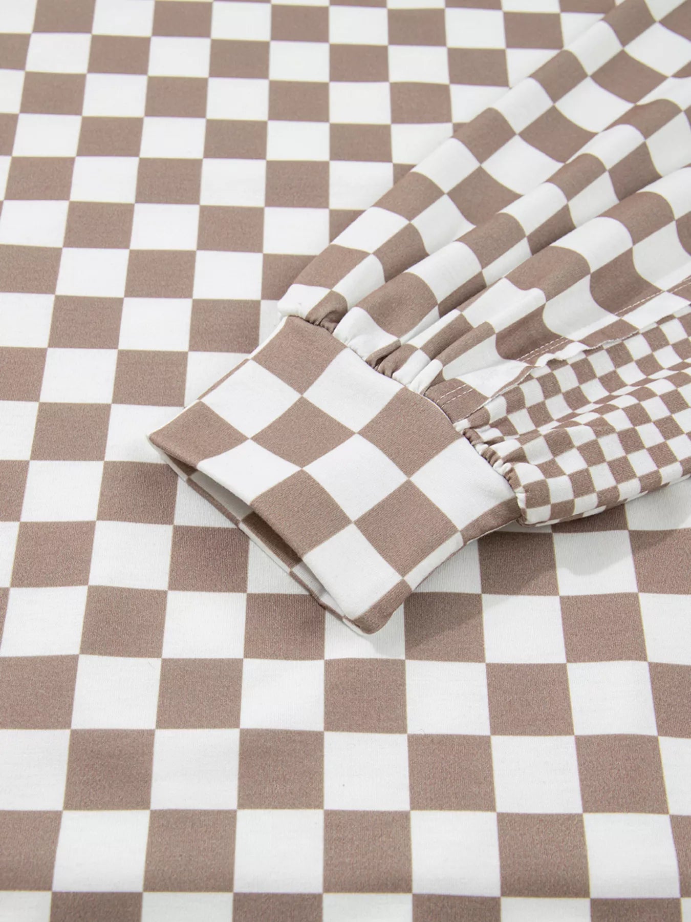 Checkered Pattern Oversized Drawstring Hoodie sleeve detail with brown and white checkered pattern.