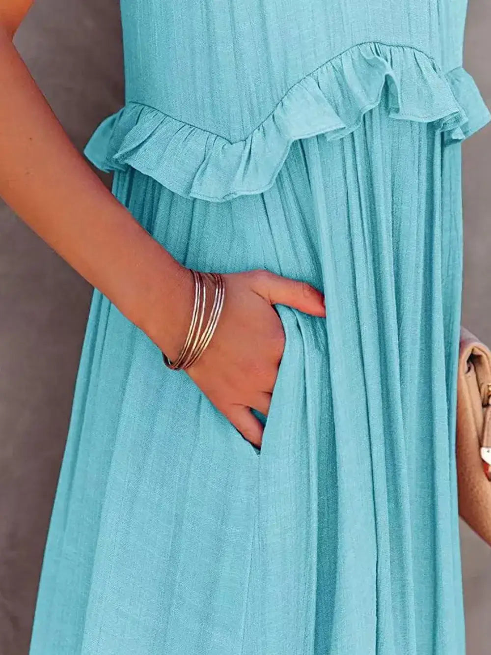Ruffled Sleeveless Tiered Maxi Dress with Pockets showcasing ruffles and a hand in a pocket.