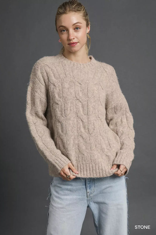 Umgee Cable Knit Cozy Sweater styled in stone color, showcasing its intricate cable knit design and relaxed fit.