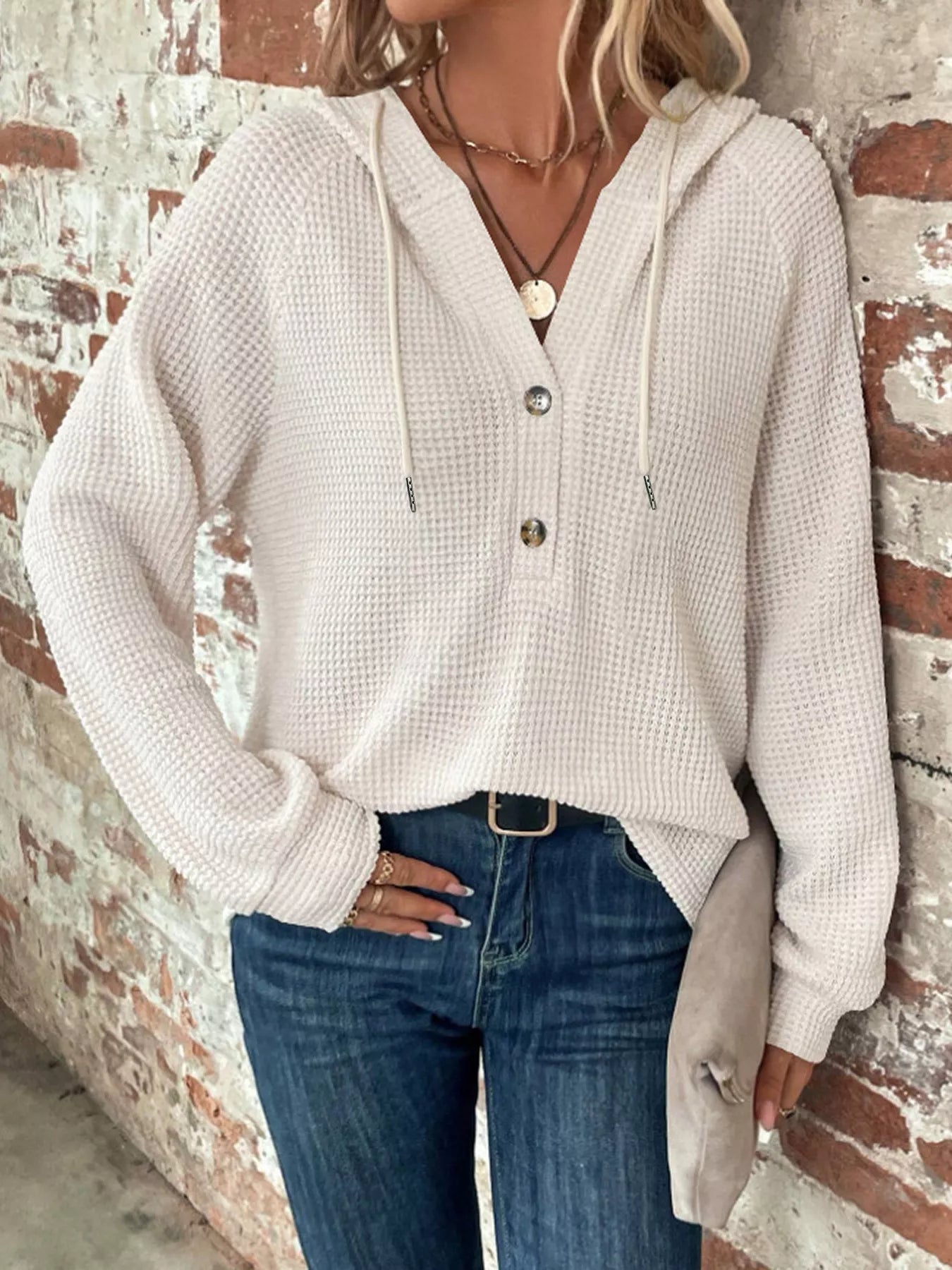 Full Size Button Detail Waffle Knit Hoodie Plus Size styled with denim against a brick wall background.