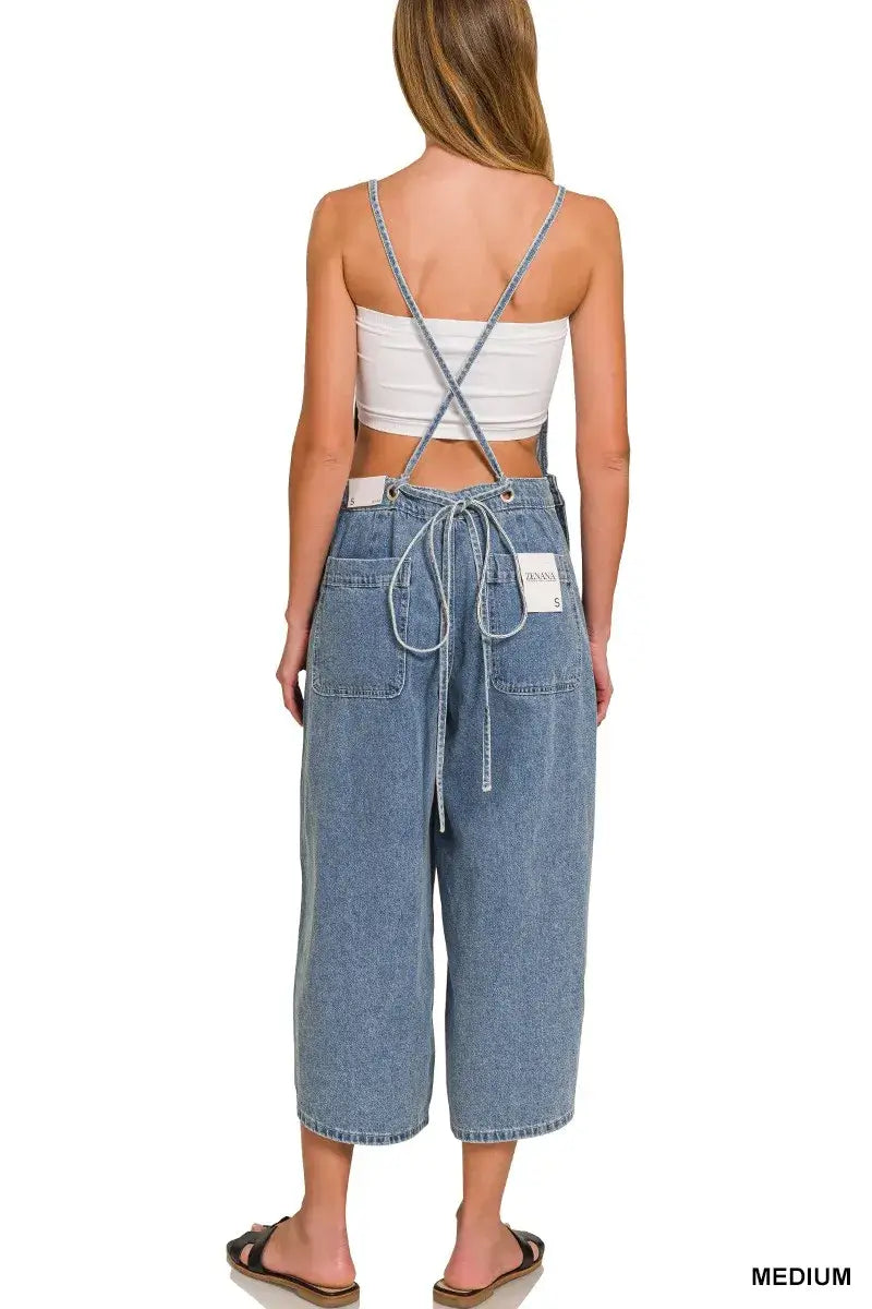 Back view of a woman wearing Zenana Denim Wide Leg Overalls in medium wash, showcasing adjustable straps and relaxed fit.