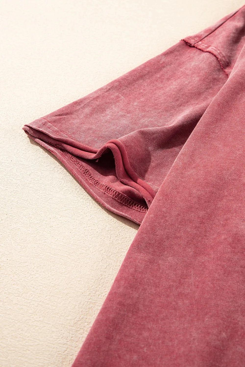 Detail of the sleeve of a One Shoulder Half Sleeve Oversized Tunic T Shirt for Women in a distressed finish.