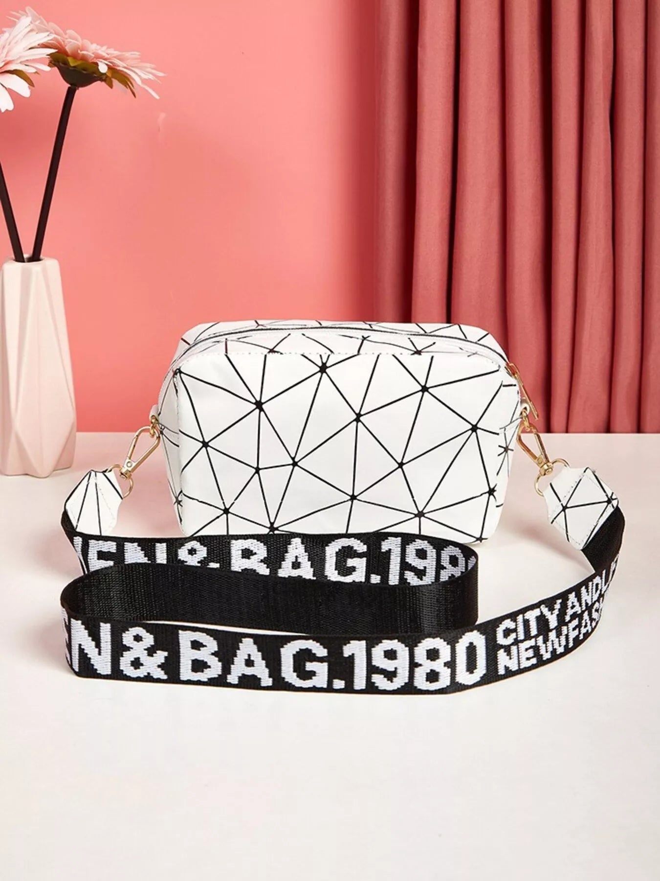Geometric Pattern Crossbody Bag featuring a white geometric design and a bold adjustable strap for a modern style.