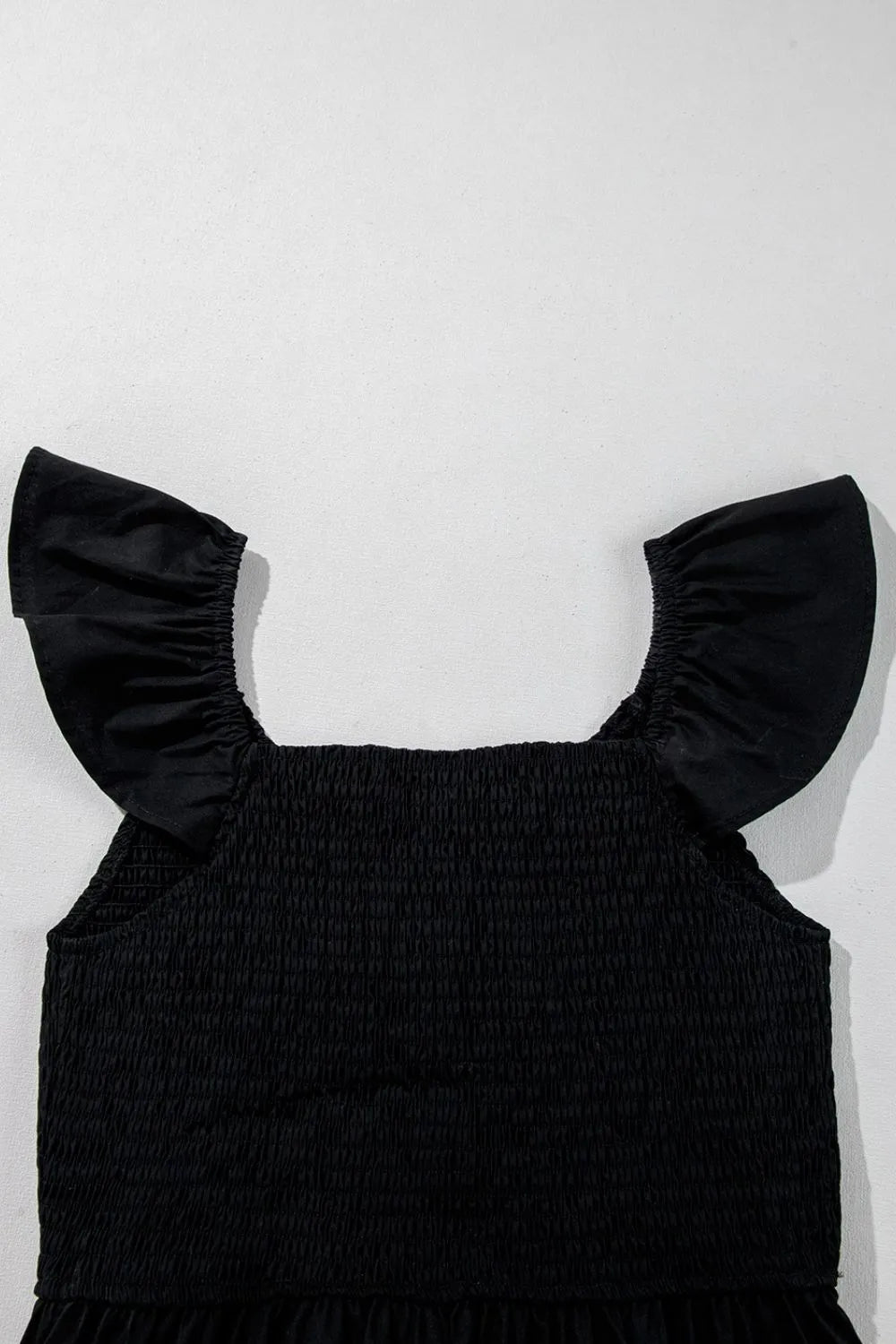 V Neck Ruffled Cap Sleeve Smocked Maxi Dress showing ruffled cap sleeves in black color.