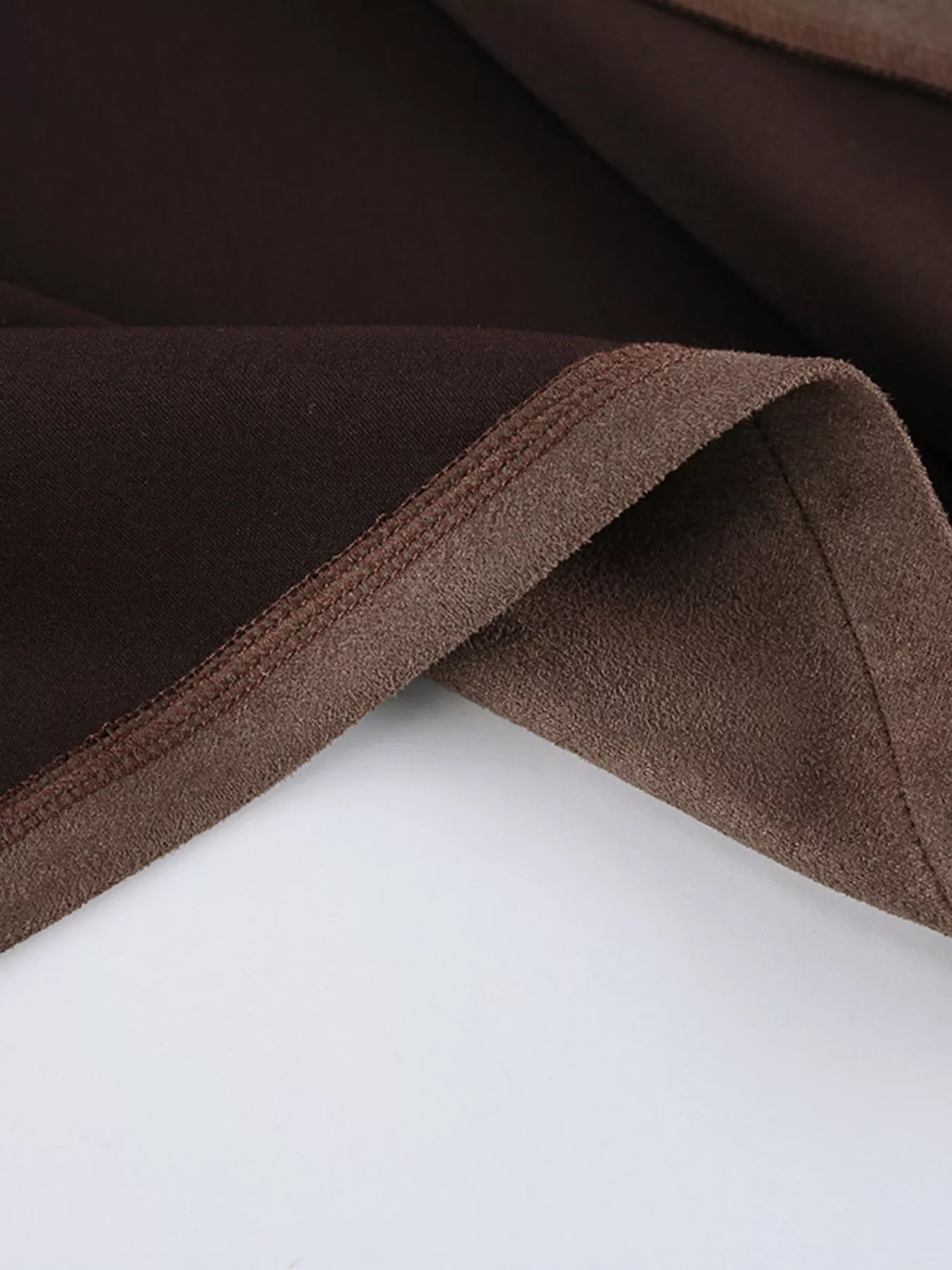 Close-up of the fabric texture and lining of the Zip-Up Dropped Shoulder Jacket in brown tones.