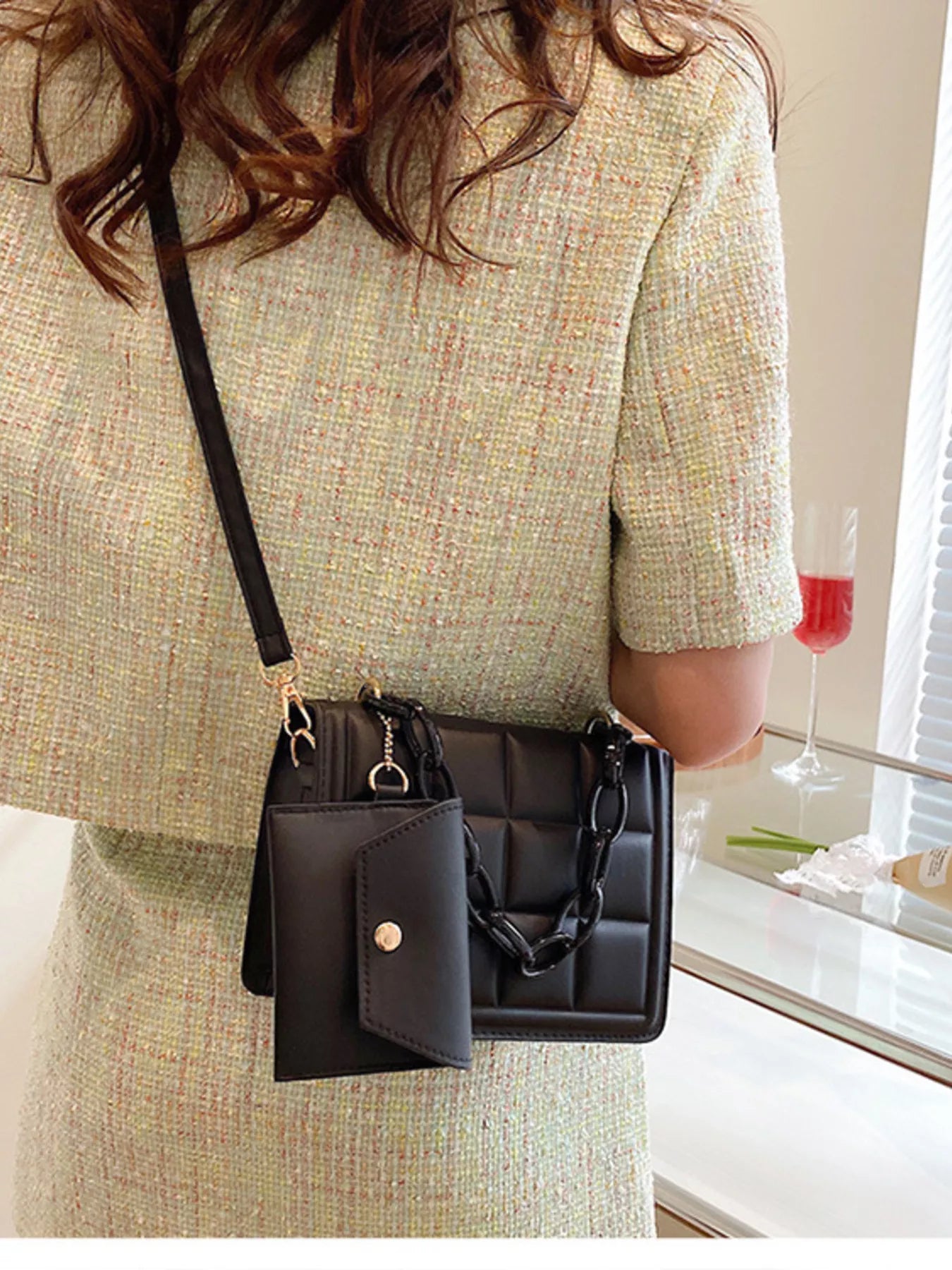 Woman wearing a Quilted Chain Strap Crossbody Bag in black PU leather with a chain strap, stylish and compact for everyday use.