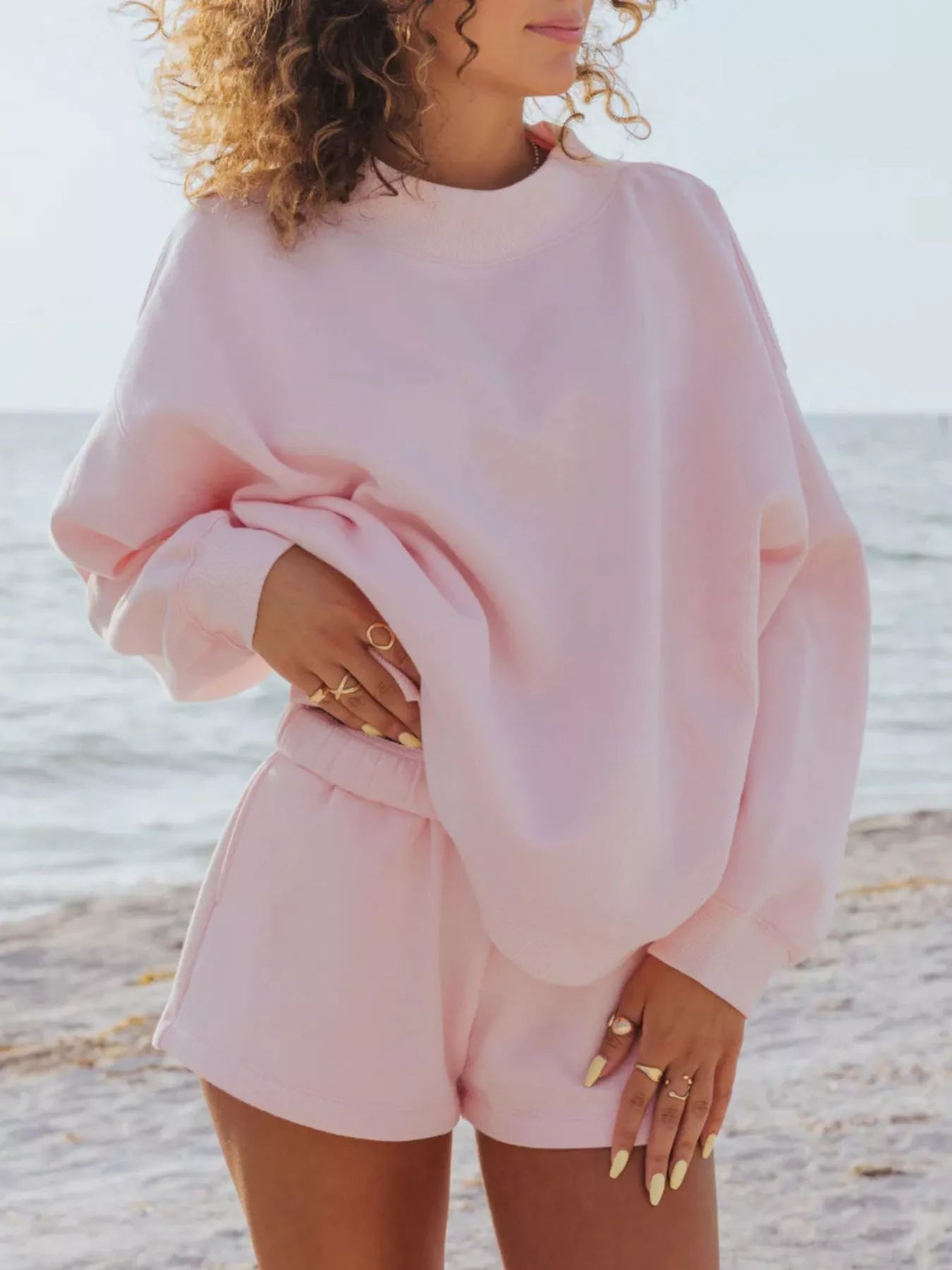 Relaxed Fit Round Neck Sweatshirt and Shorts Set in pink, casual style for a comfortable beach day look.
