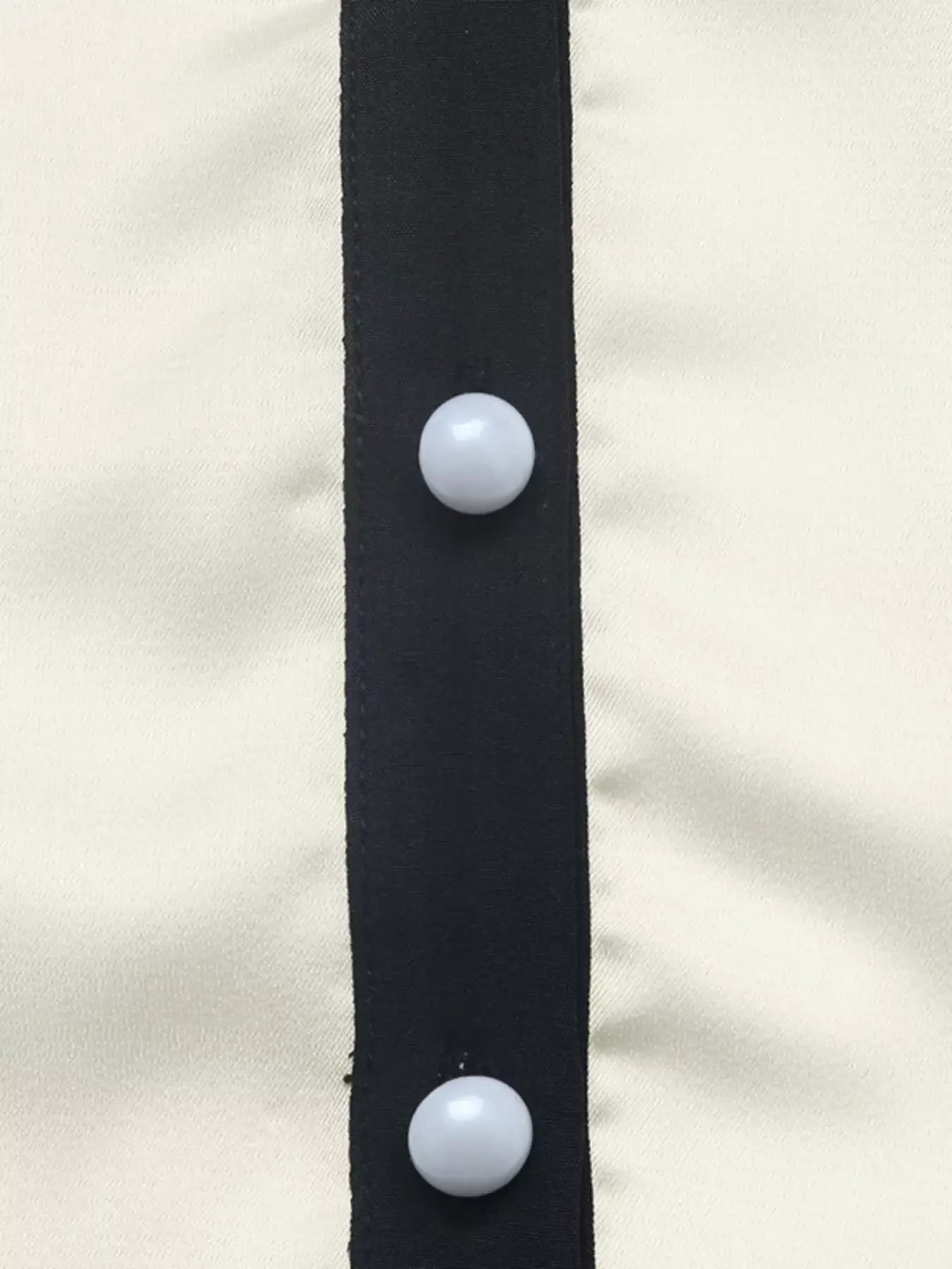 Close-up of Contrast Trim V-Neck Blouse featuring button detail and contrasting trim.
