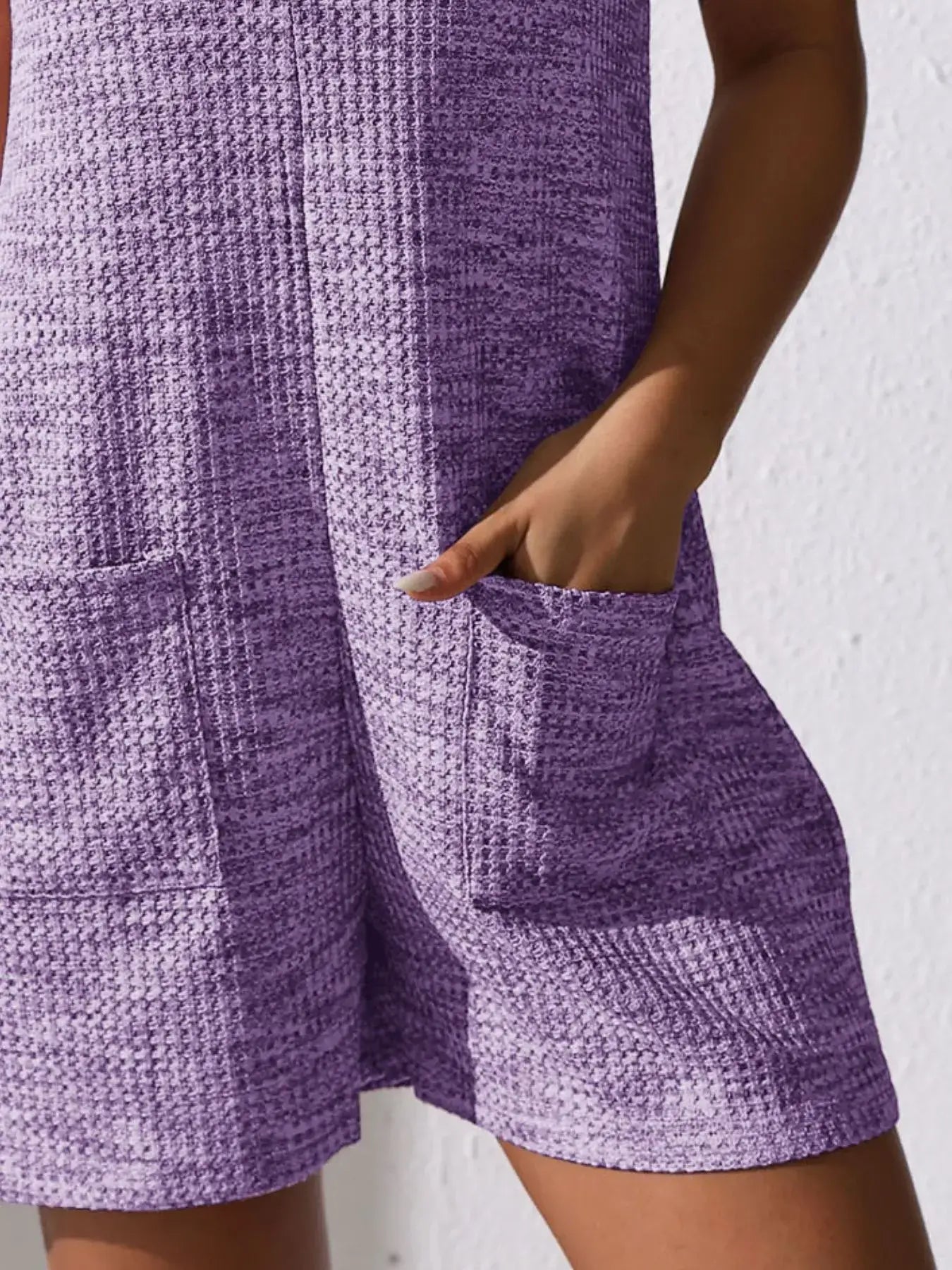 Full Size Button Front Romper with Pockets in a purple color, showcasing pockets and a relaxed fit.