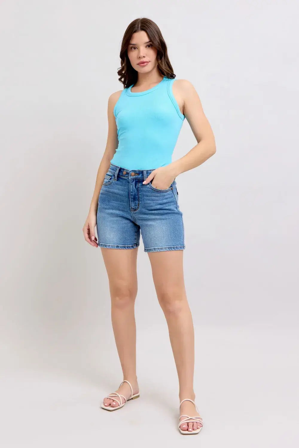 Model wearing Judy Blue Plus Size Denim Shorts with light blue tank top and sandals.