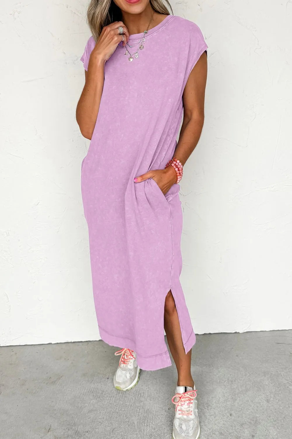 Woman wearing a Side Split Round Neck Cap Sleeve T-Shirt Dress in pink, featuring pockets and a stylish slit.