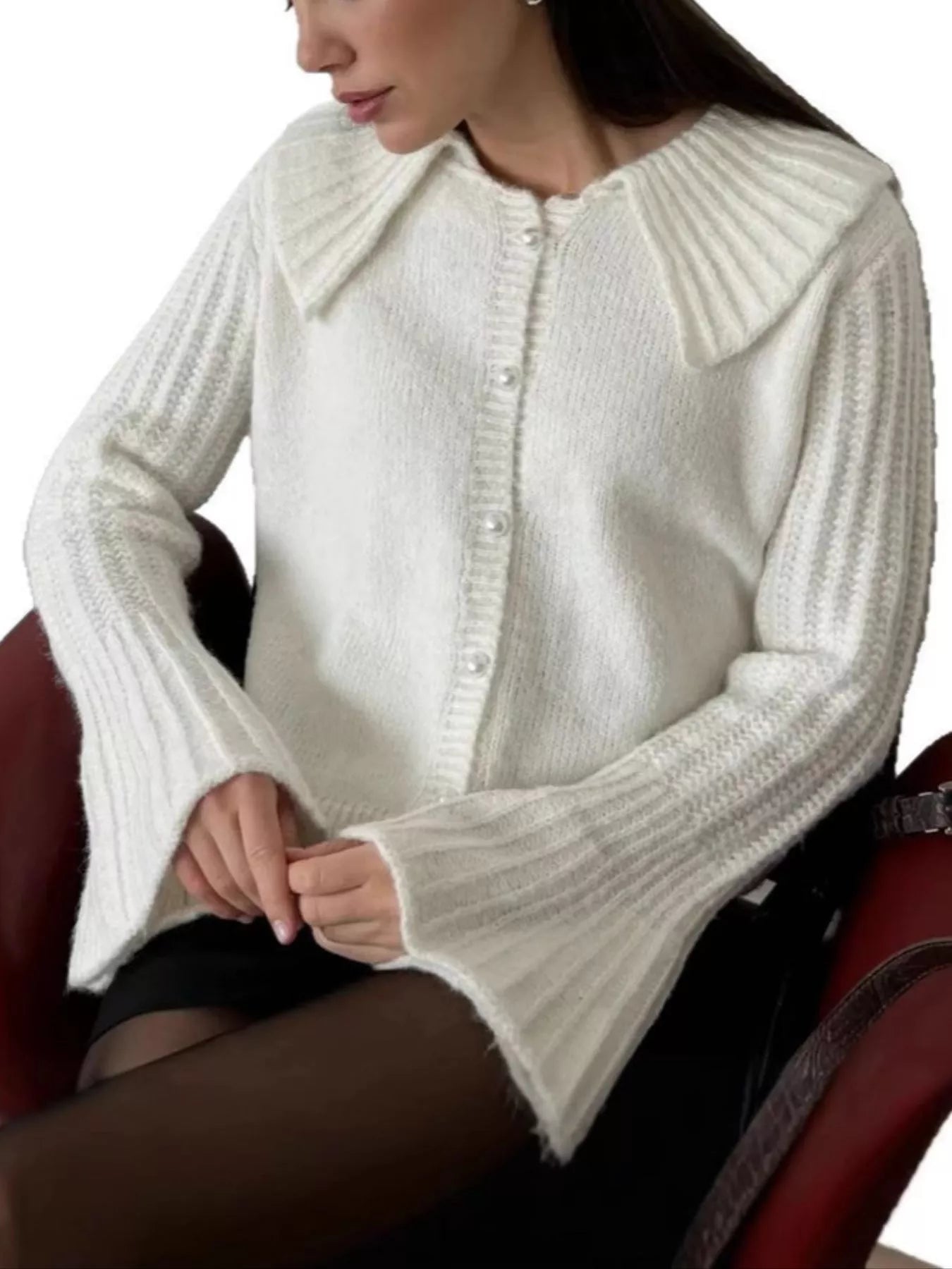 Woman wearing a Button Up Flare Sleeve Cardigan in white, featuring a collar and bell sleeves, showcasing elegant knit design.