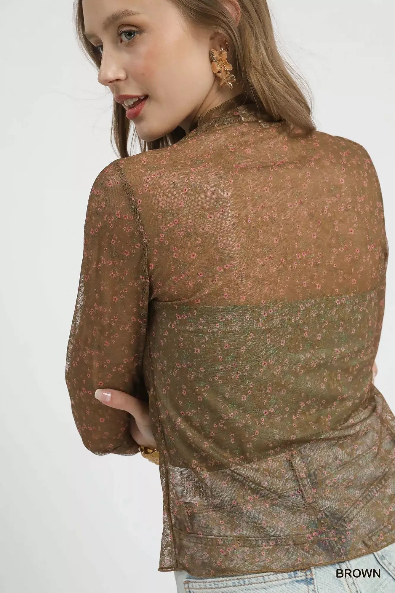 Model wearing umgee nylon lace mesh long sleeve top with delicate floral patterns and elegant sheer style.