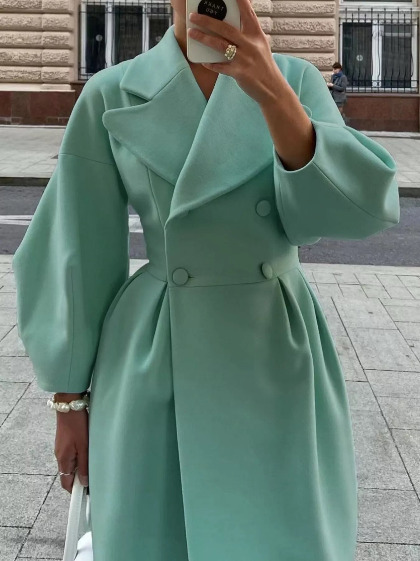 Double-Breasted Longline Coat displayed in a light mint color with a tailored silhouette and buttoned design.