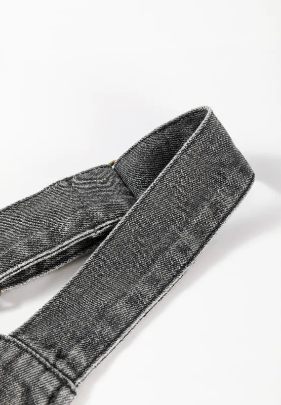 Close-up of the strap on a Wide Strap Button Down Denim Overall Dress, showcasing its denim texture and stitching.
